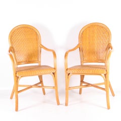 Pair of rattan and hand woven leather armchairs