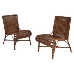 Vintage Pair of rattan and wicker fireside chairs, 1950s.