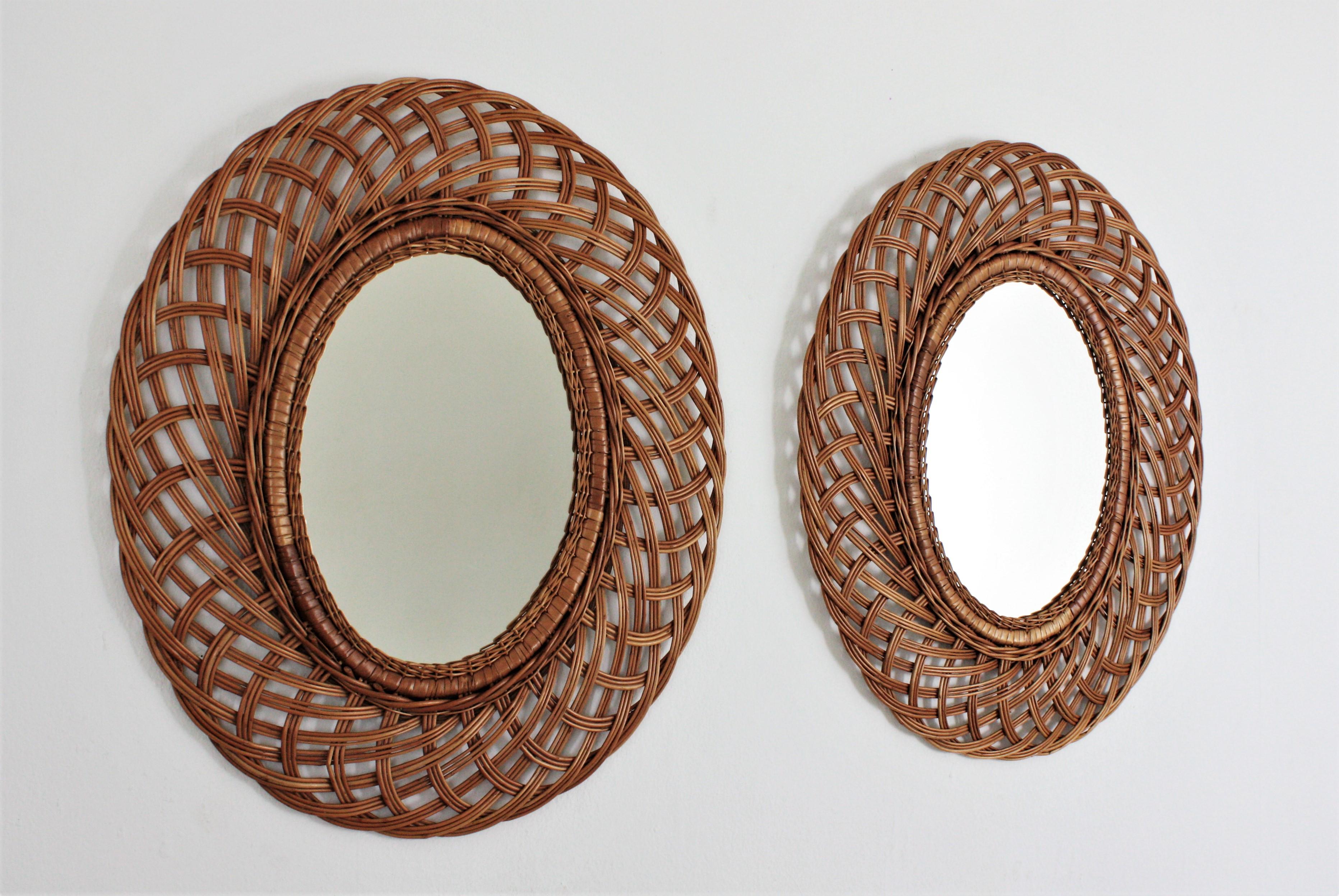 Pair of Mid-Century Modern woven rattan and wicker oval mirrors, Spain, 1960s.
These Mediterranean wall mirrors feature an oval glass surrounded by an intricate of rattan or wicker canes frames.
They will add a fresh accent wherever you place