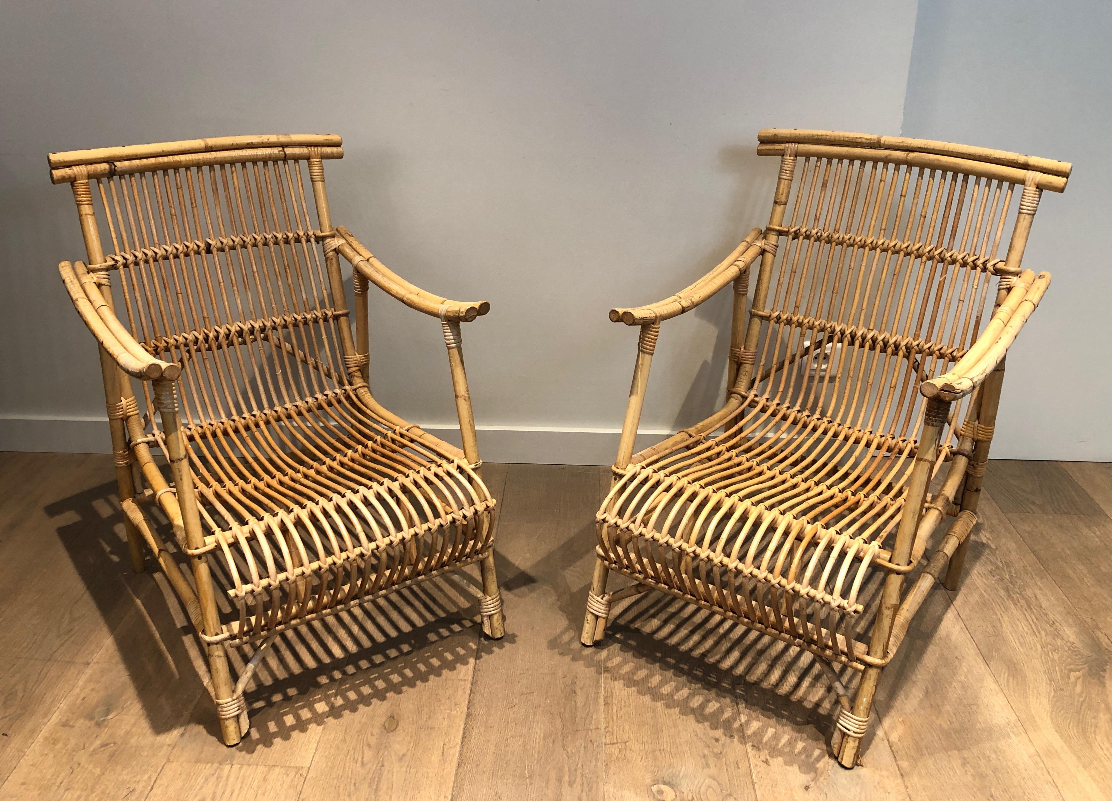 This very nice and unusual pair of armchairs are made of rattan. This is a French work. circa 1950.