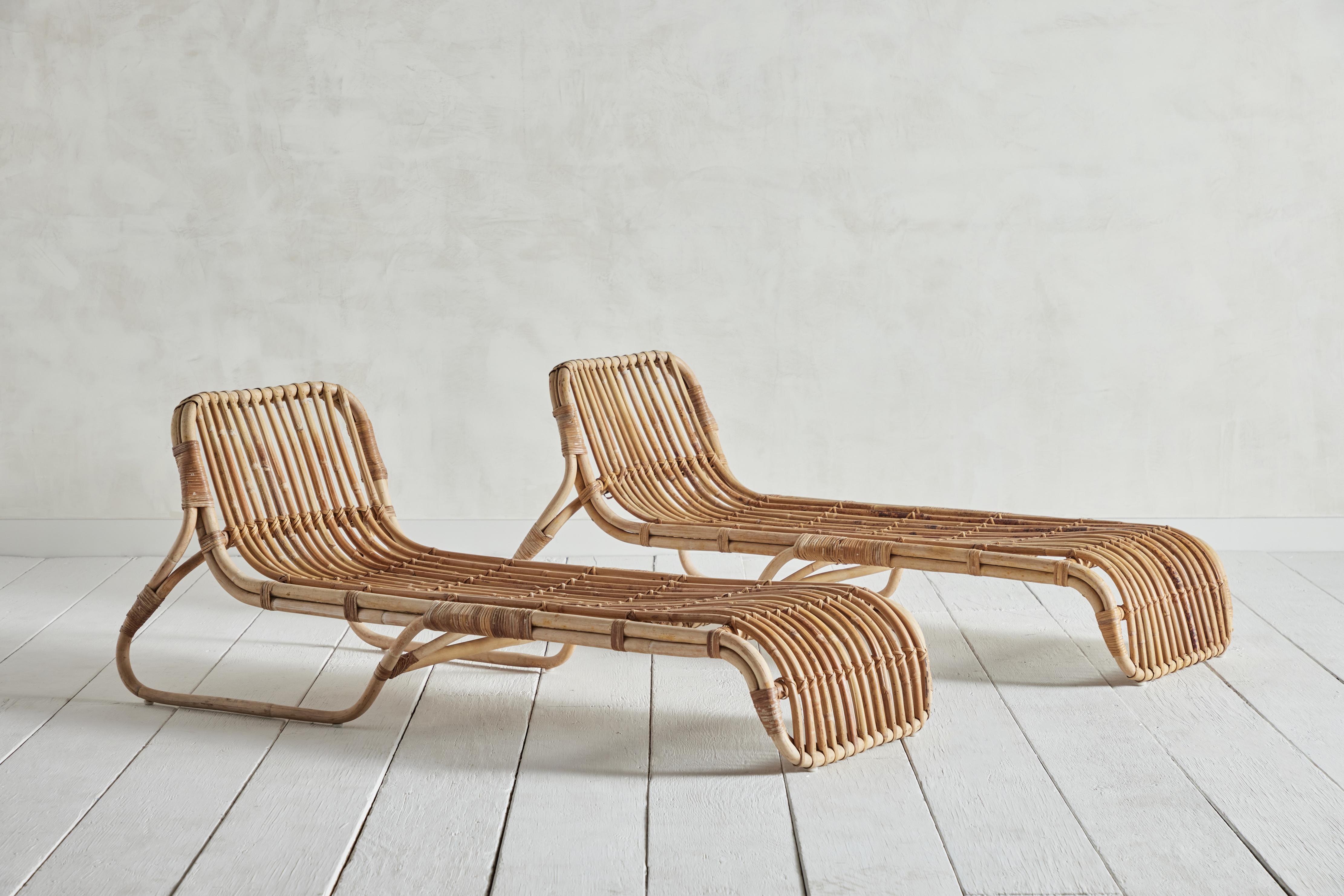 Pair of two rattan chaise lounge chairs from France circa mid 20th century.