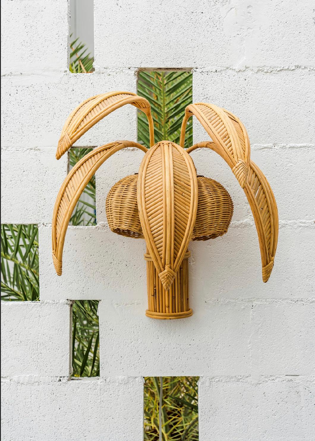 Pair of lovely very decorative rattan « coconut tree » sconces with 5 adjustable palms that come off for the shipping and lights in the coconuts. Unique sculptural design typical of the seventies, it is a high quality work, entirely hand made.