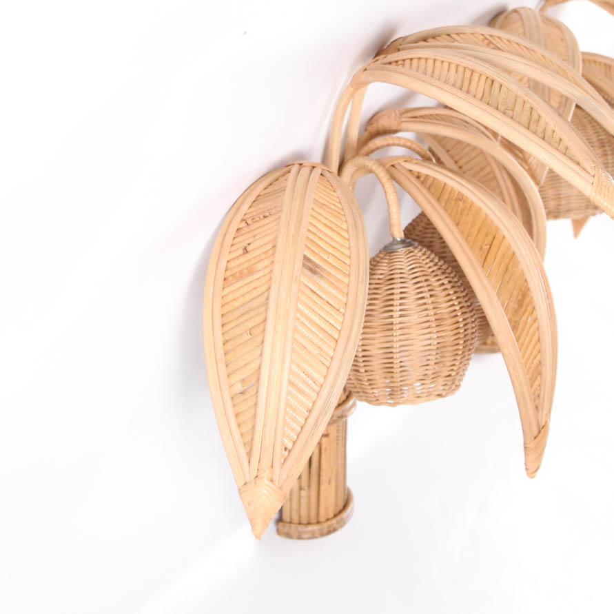Pair of lovely Italian rattan coconut tree wall lights/sconces with 5 adjustable palms that come off for the shipping and lights in the coconuts. Unique sculptural design typical of the seventies, it is a high quality work, entirely hand made.