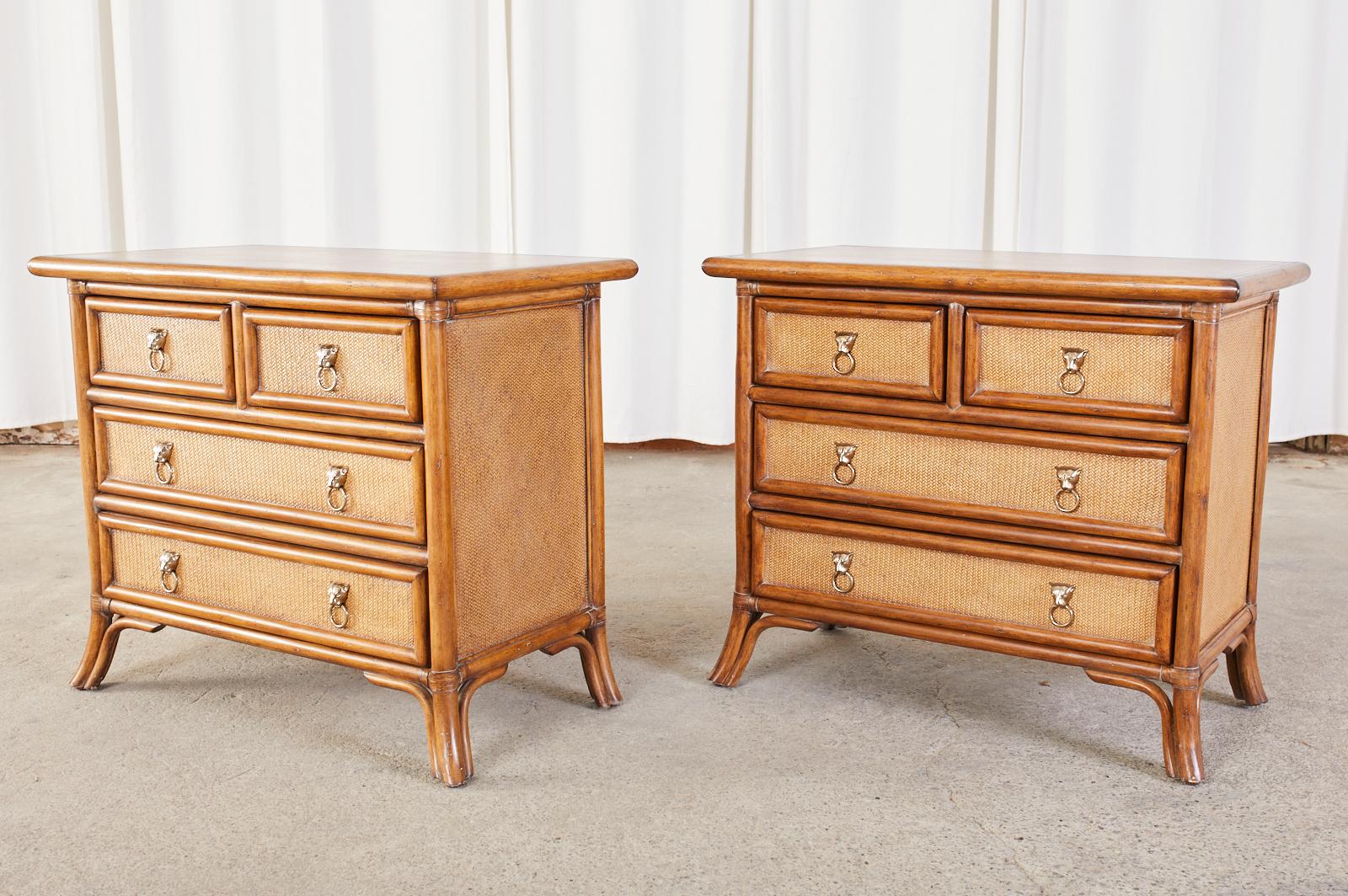 Fabulous pair of rattan nightstands made in the organic modern style by Kreiss. The chests feature a rattan frame with a leather top and raffia grasscloth inset. Fronted by five large storage drawers with silvered lions head ring pulls. Each drawer