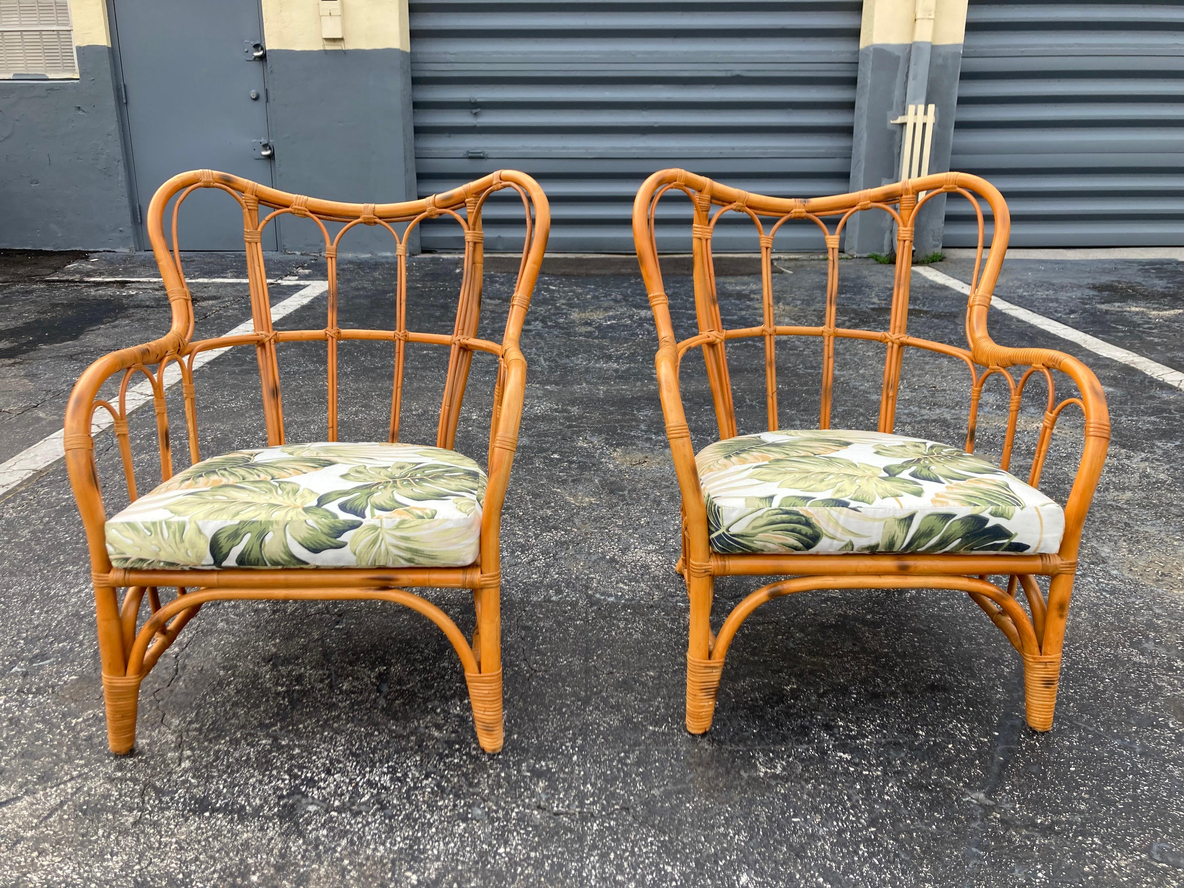 Pair of Rattan Lounge Chairs with fabric seats.