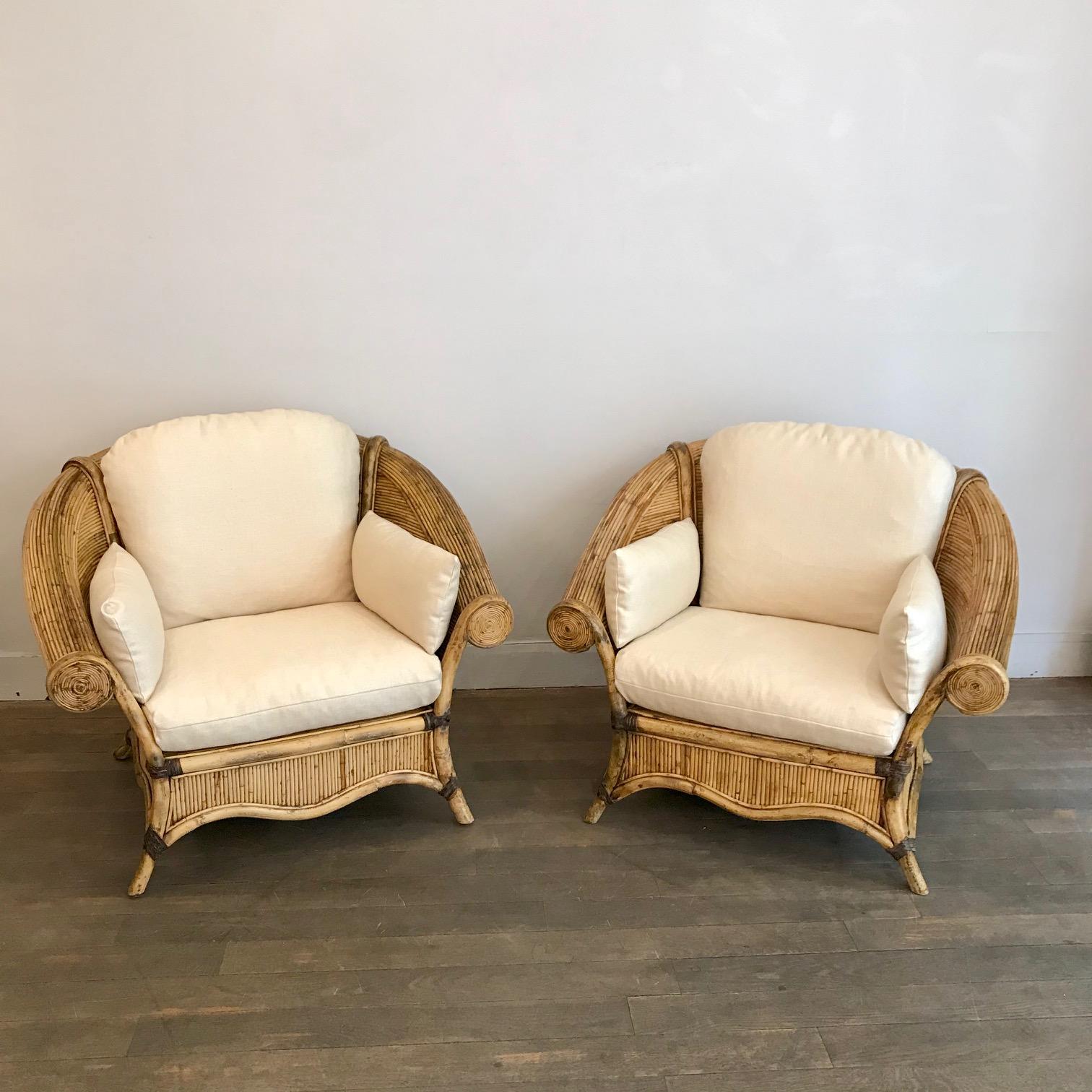 Pair of rattan lounge chairs
Rattan held by leather straps
France, 1960s

Newly re upholstered in beige cotton and linen fabric

Measures: Height 30.7 in. (78 cm)
Width 38.6 in. (98 cm)
Depth 30.3 in. (77 cm)
Height seat 15.3 in. (39 cm).
 