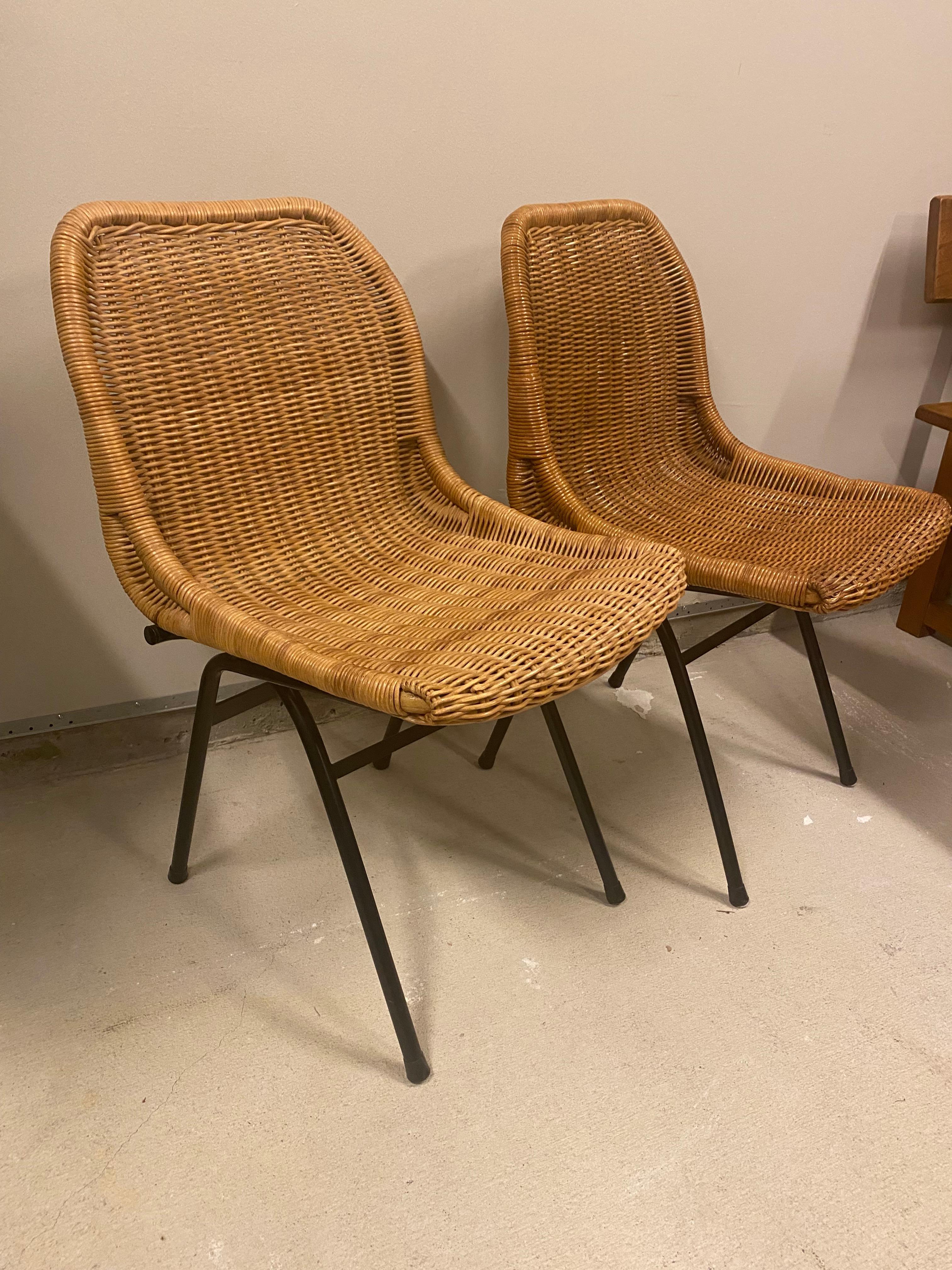 Charming and comfortable set of natural woven wicker or rattan side or dining chairs on powder coated black steel frames, by Dirk van Sliedregt (also spelled Sliedrecht.) The Netherlands, 1960's. Sold as a pair. 

 