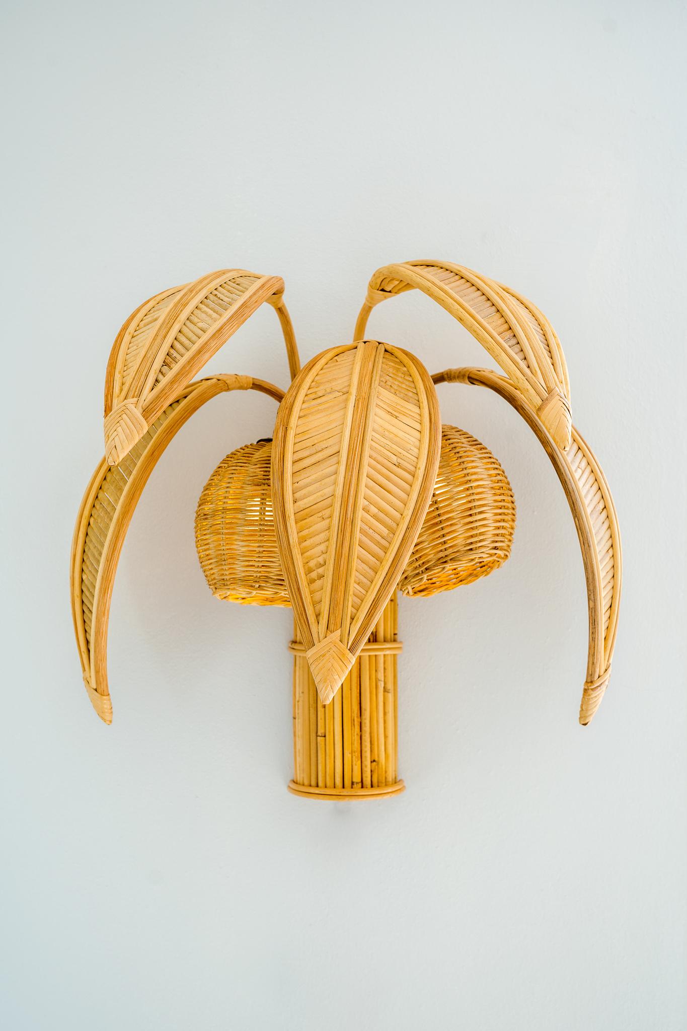 Pair of lovely Italian rattan coconut tree wall lights/sconces with 5 adjustable palms that come off for the shipping and lights in the coconuts. Unique sculptural design typical of the seventies, it is a high quality work, entirely hand made.