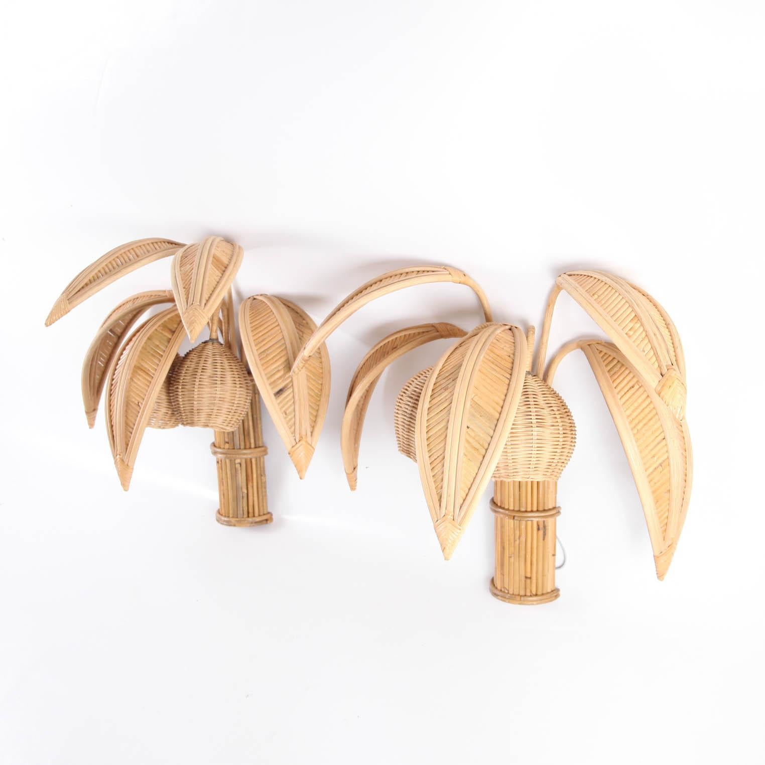 Pair of lovely rattan coconut tree wall lights/sconces with 5 adjustable palms that come off for the shipping and lights in the coconuts. Unique sculptural design typical of the seventies, it is a high quality work, entirely hand made. Beautiful