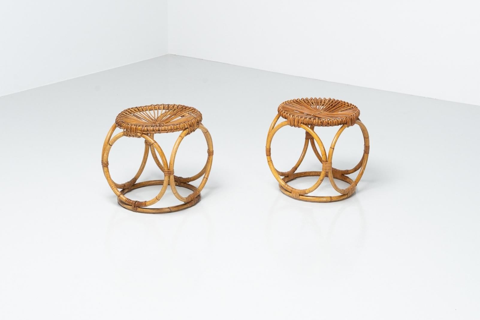 Interesting pair of stools in rattan, made in spain ca 1950. The condition is very good, no signs of heavy usage or weakened parts of framework. These particular stools have unusual shaped frames and a beautifully woven pattern on top, and are a