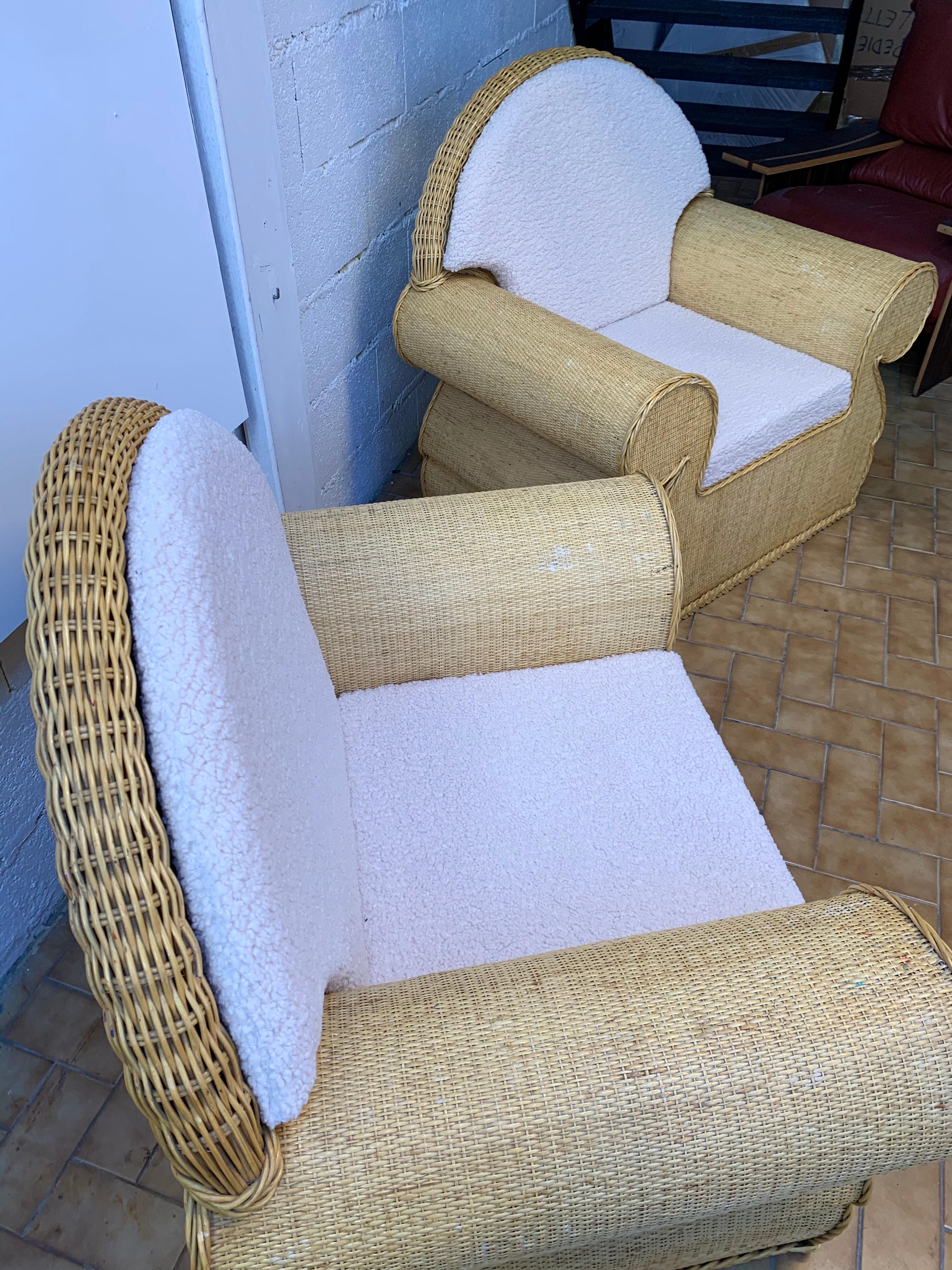 Large pair of rattan wicker armchairs or lounge chairs style club. New upholstery with a bouclé fabric. In the style of Vivai del Sud, Tito Agnoli, Hollywood Regency.