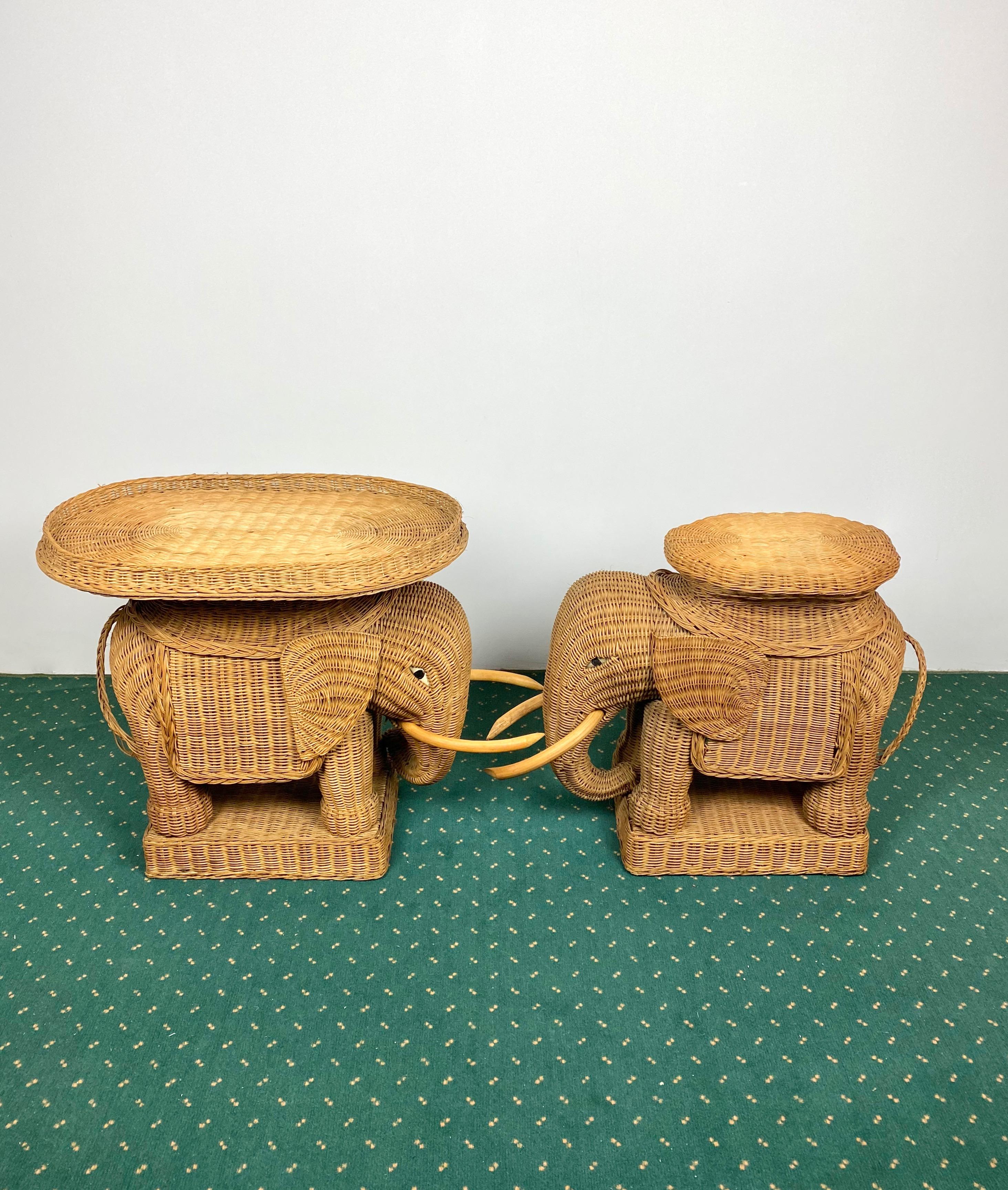 Pair of eye-catching elephant-shaped end tables and coffee tables constructed in hand-braided rattan accented with wood tusks. One has also a removable tray on top. Made in France, 1960s. 

 