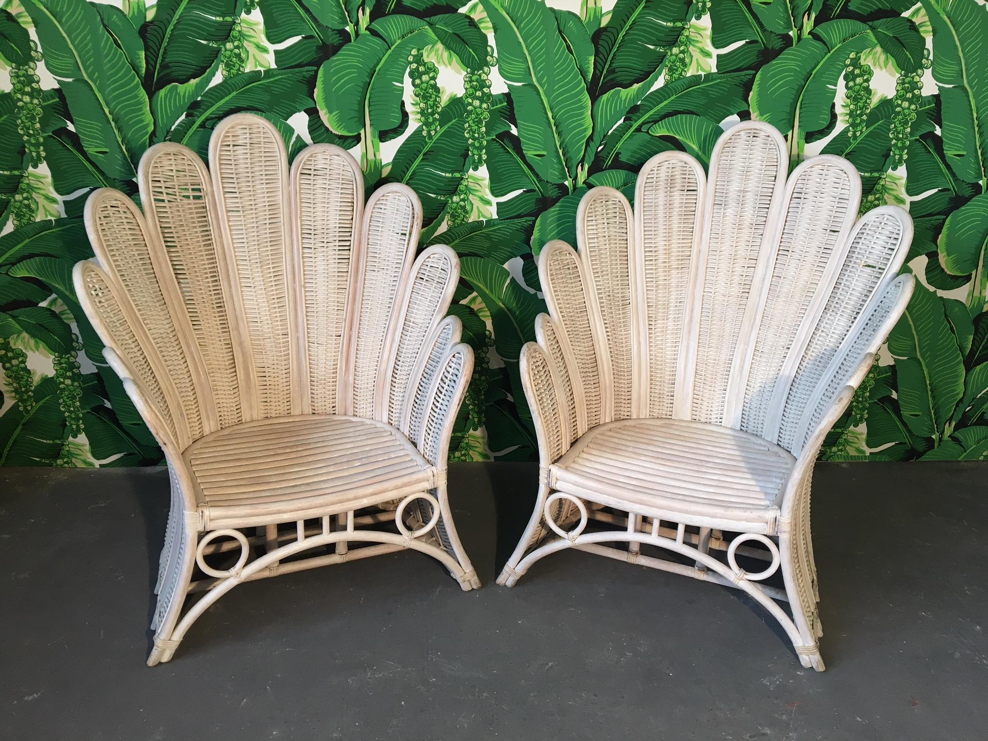 Set of two rare peacock fan back chairs in white washed rattan. Some damage to each, see photos. Structurally very sound.  Professional reupholstery available, ask for details.