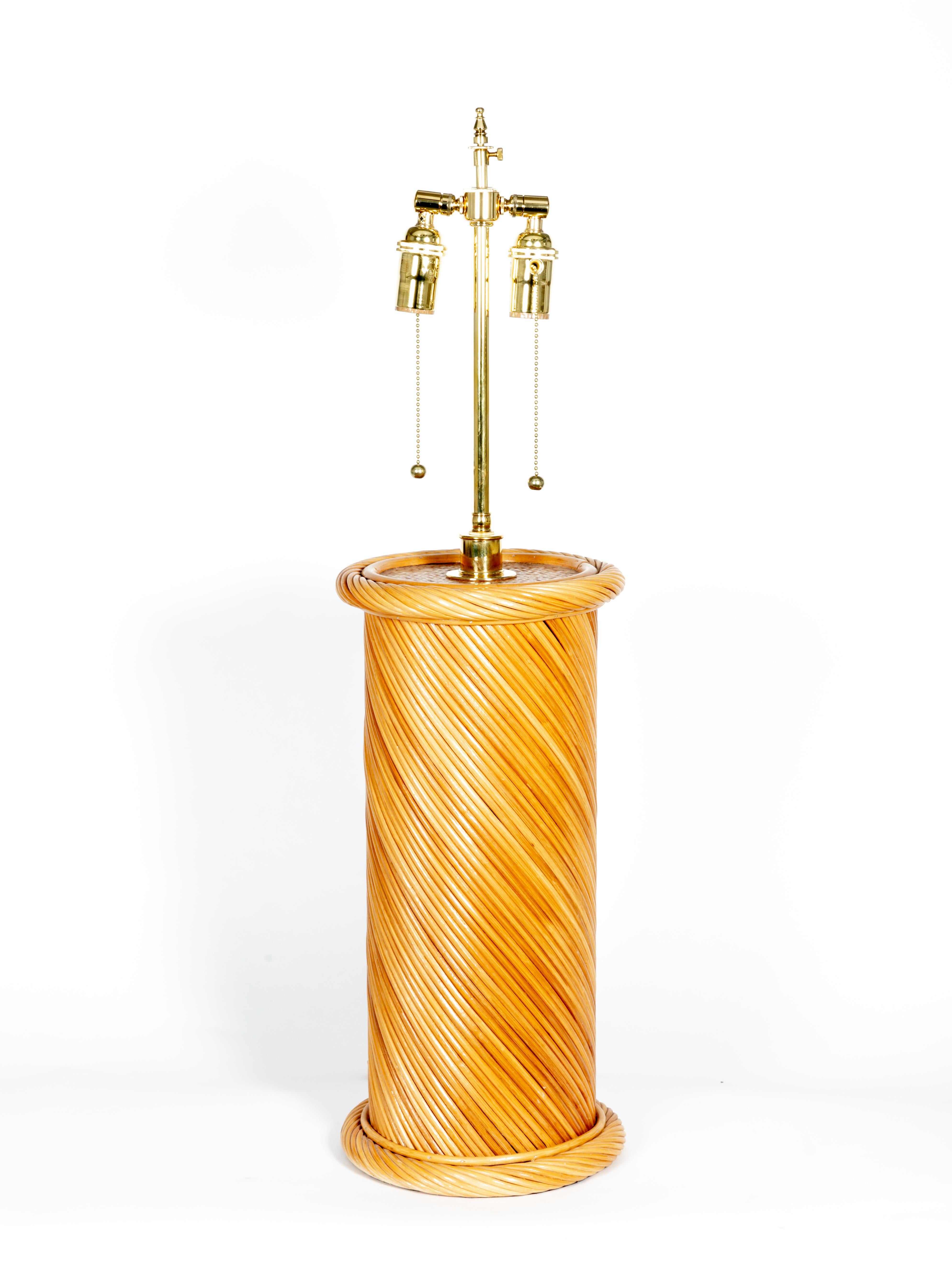Pair of rattan woven table lamps with brass detail.