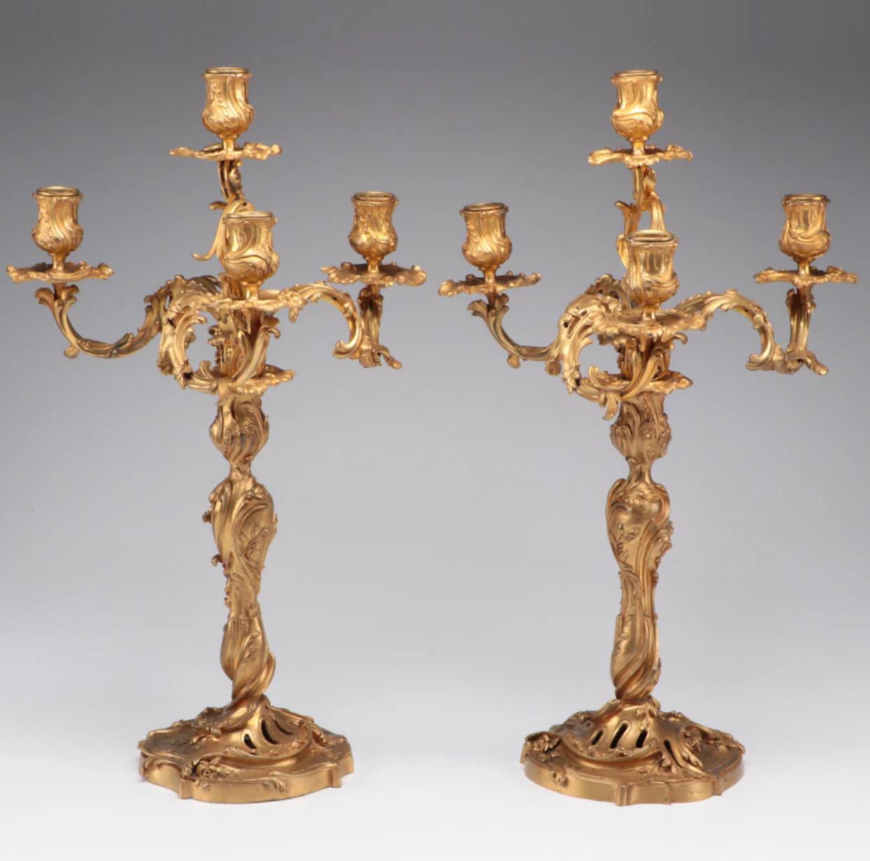 Pair of D’Ore Bronze four light candelabra with incredible acanthus leaf ormolu. Each candle holder is finished with a decorative bobeche. Heavy, and as the name reflects, very well cast. Hallmarks Ravinet D’Enfert. 

The company founded in 1845 by
