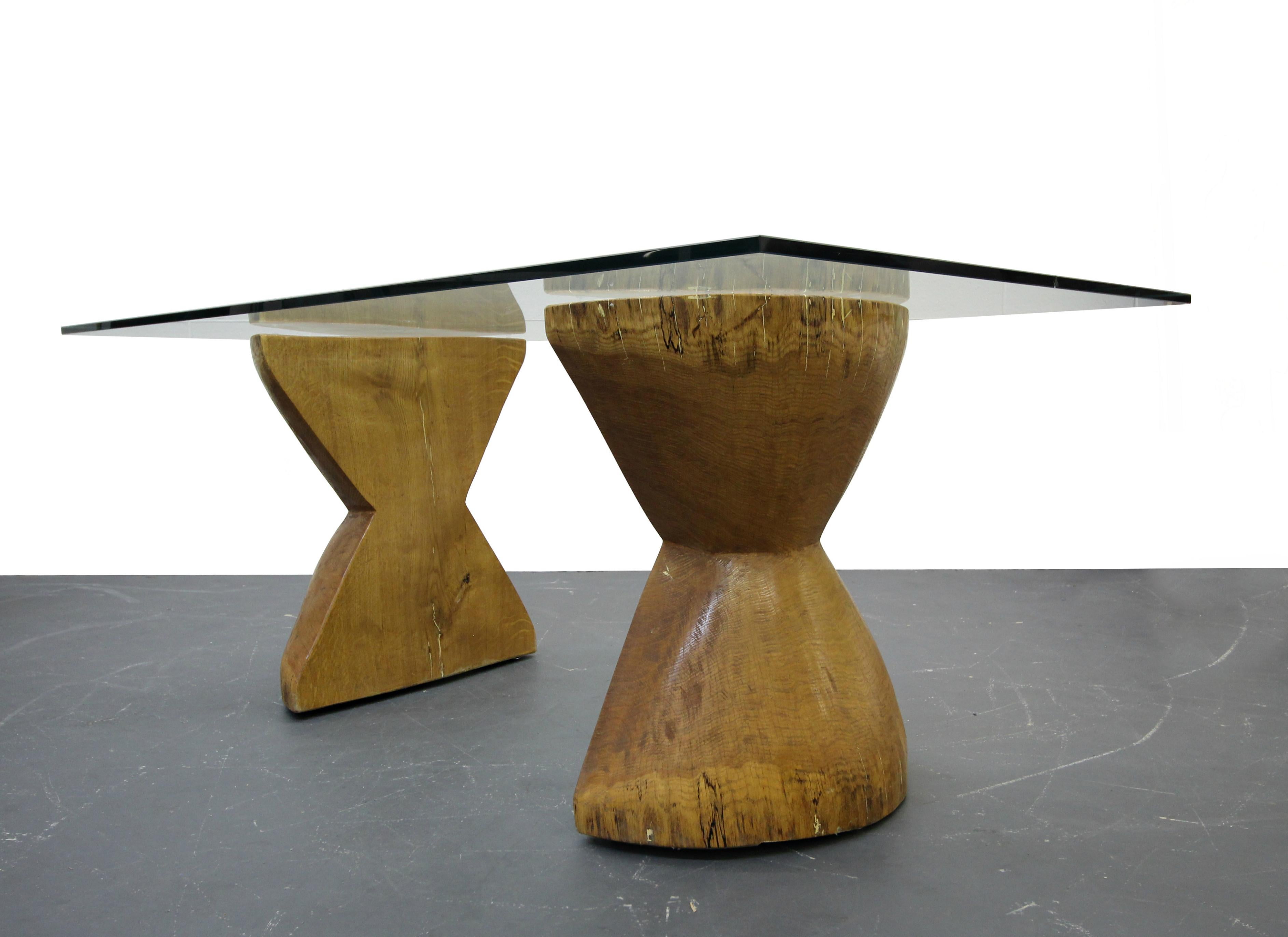 Completely unique and one of a kind twist to your traditional live edge table. These hourglass shaped pedestals are solid wood and could easily support a huge piece of glass. They would make a beautiful dining table or desk. Very clean Minimalist
