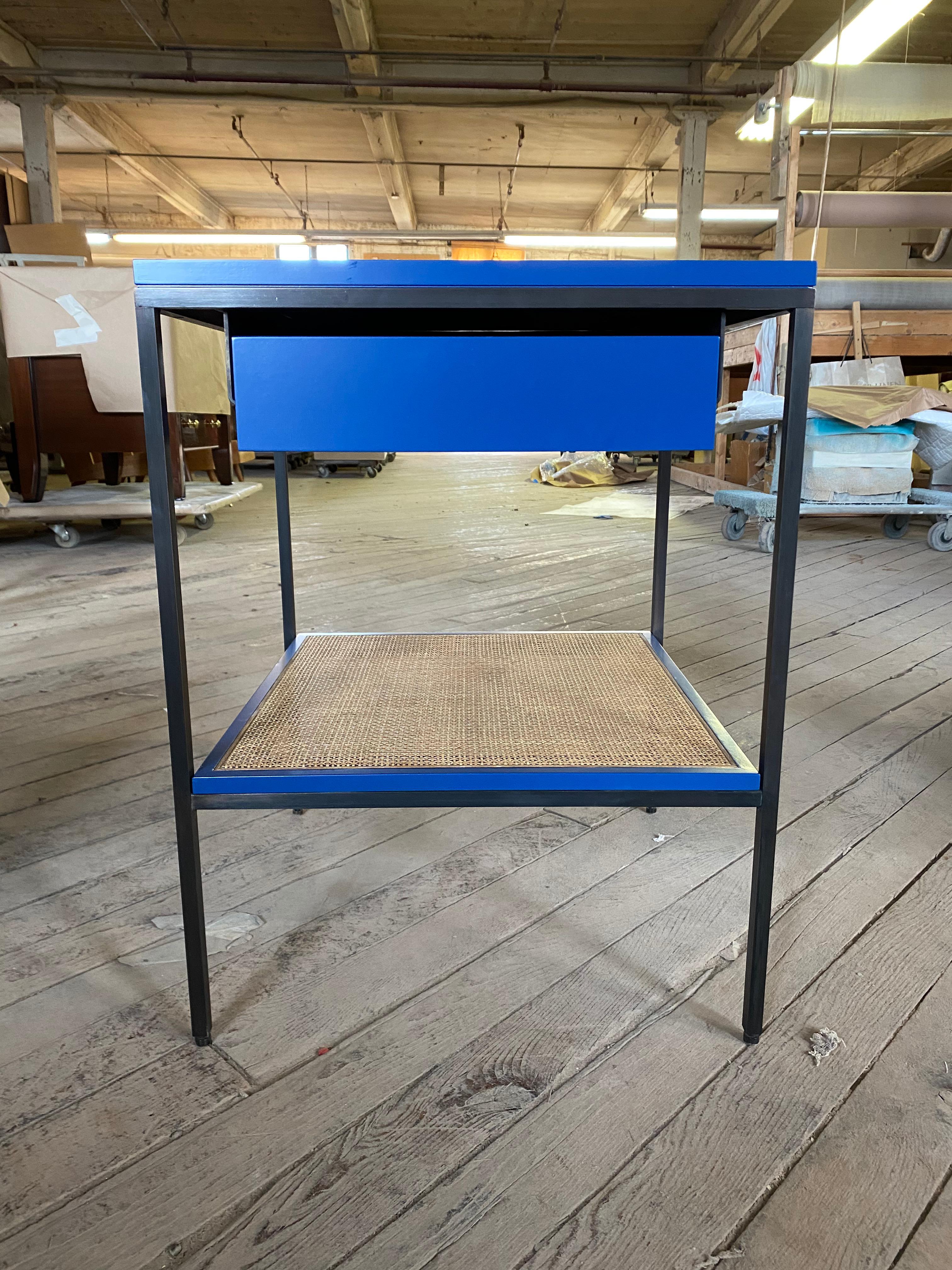 Our classic lacquer, cane and bronze bedside tables in our standard size. Shown here in BM Downpour blue #2063-20 on oiled bronze frames with medium toned caned shelves. Made to order. Local manufacturing with flawless attention to detail.