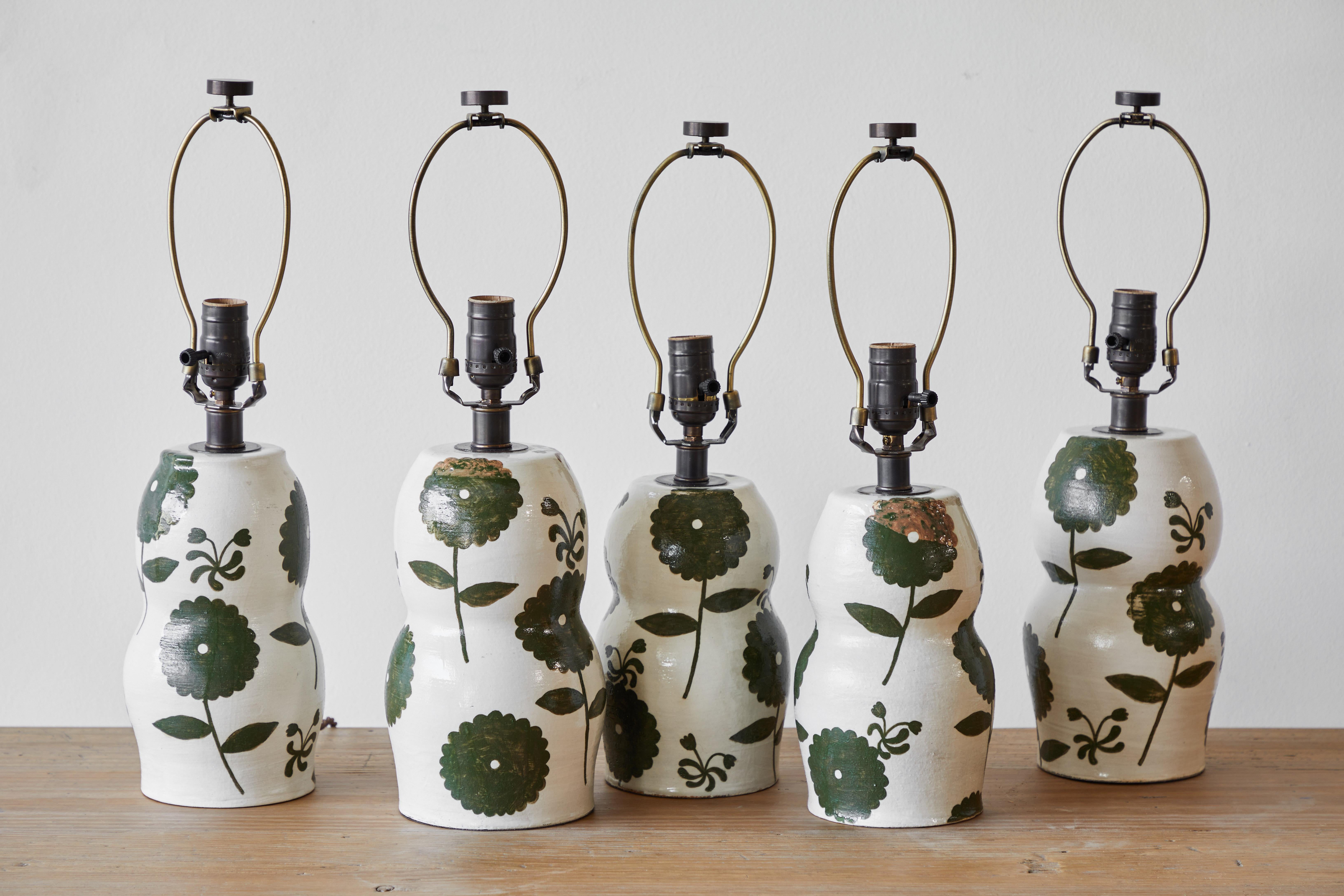 These beautiful lamp bases are custom made and hand painted by the artist Rebekah Miles in Ojai, California. Sold as a pair. Due to the handmade nature of these lamp bases, sizes and glaze may vary. No two bases are exactly alike. The lamp base