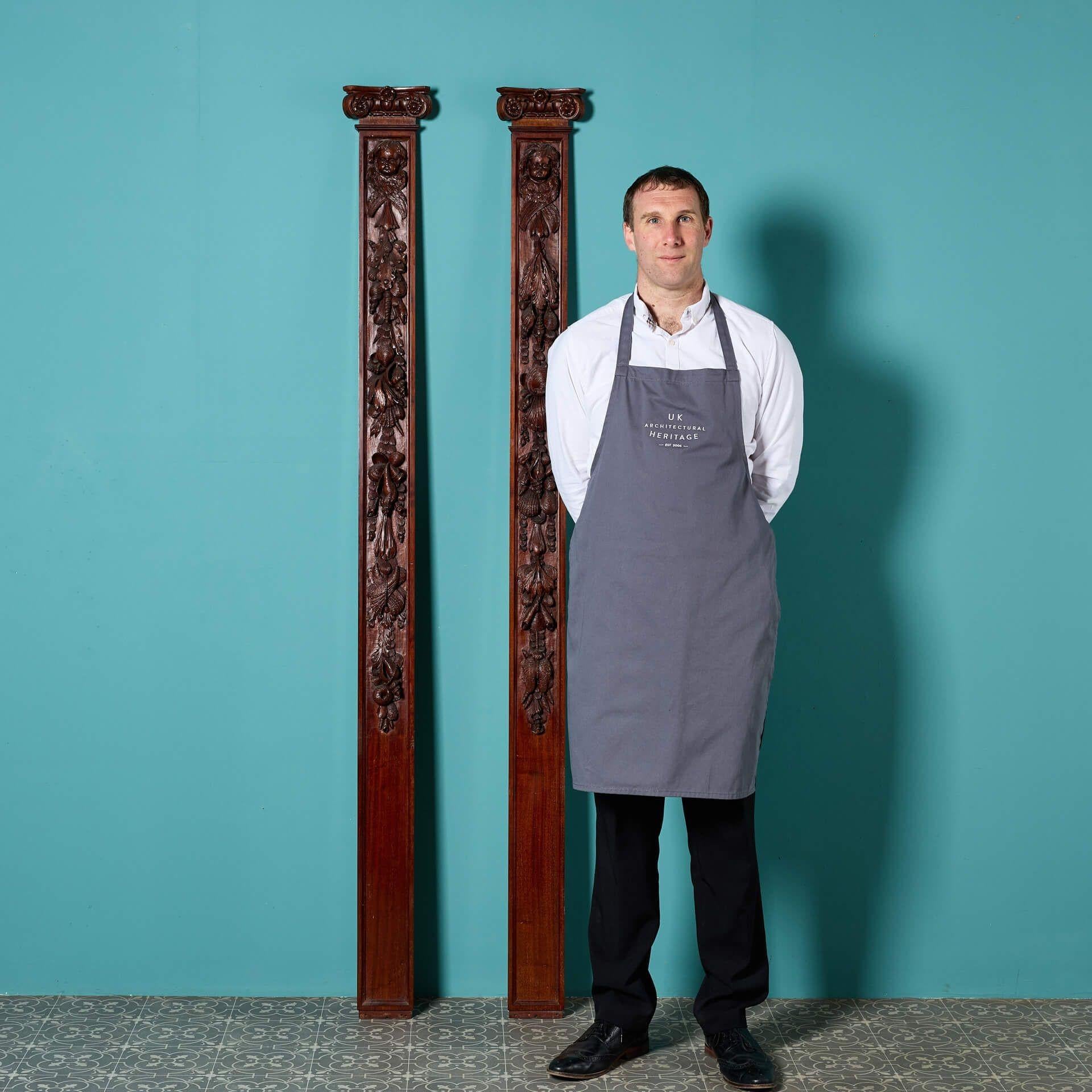 A handsome pair of late 19th/early 20th century reclaimed carved mahogany pilasters with French polish finish. These are just two of a series of architectural elements reclaimed from Worth Estate, West Sussex.

Standing at just over 2m tall, these