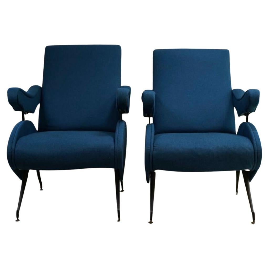 Beautiful pair of reclining lounge chairs in original blue fabric by Nello Pini for Novarredo. 

The interior mechanical mechanism which sits beneath the arm rest allows the armchair to be adjusted and tilted back. The chair is supported on iron