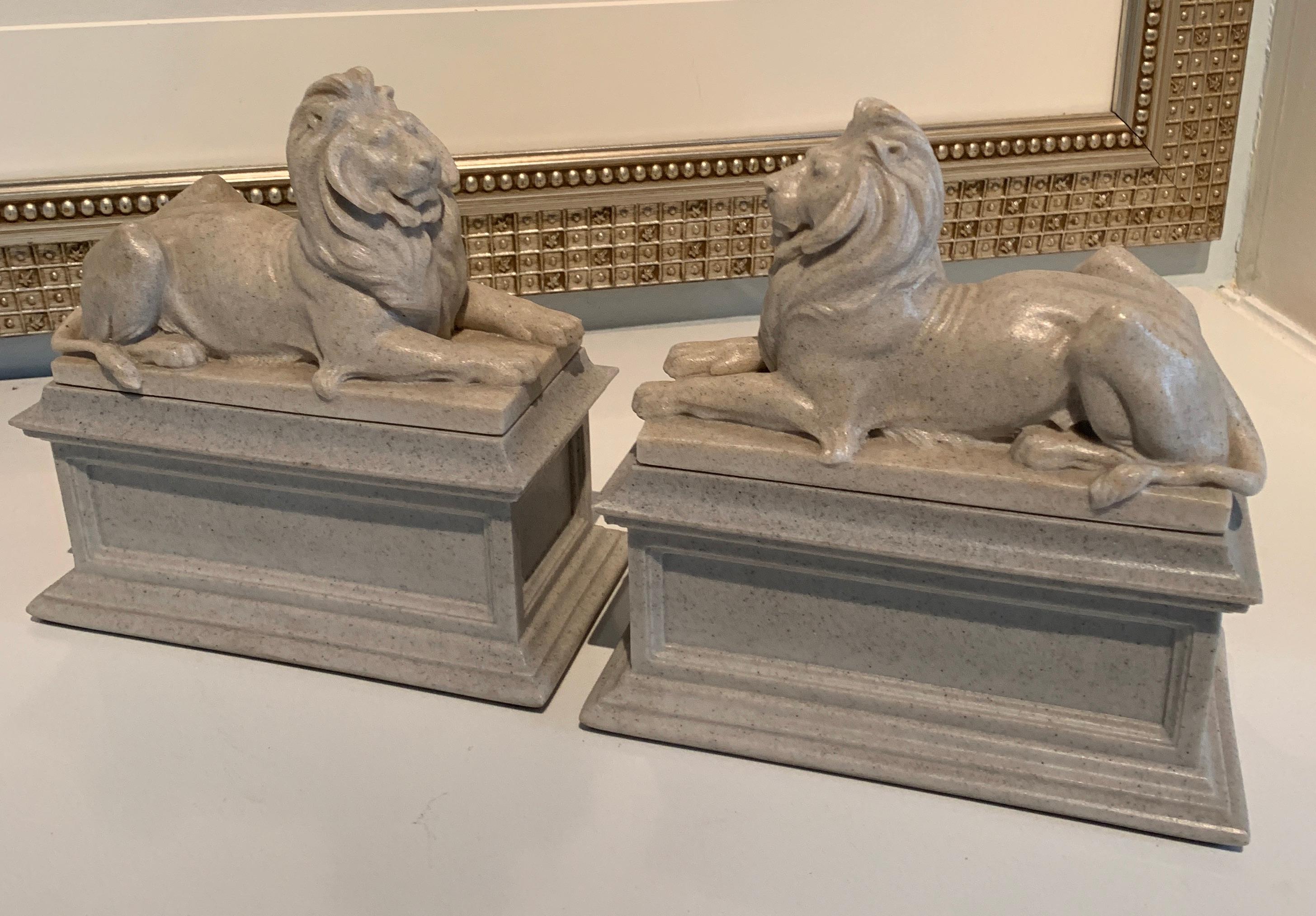 A pair of reclining lion bookends, a stunning pair with the look of limestone, but a composition material. The pair are of good weight for those larger books... looking great on any shelf or desk.