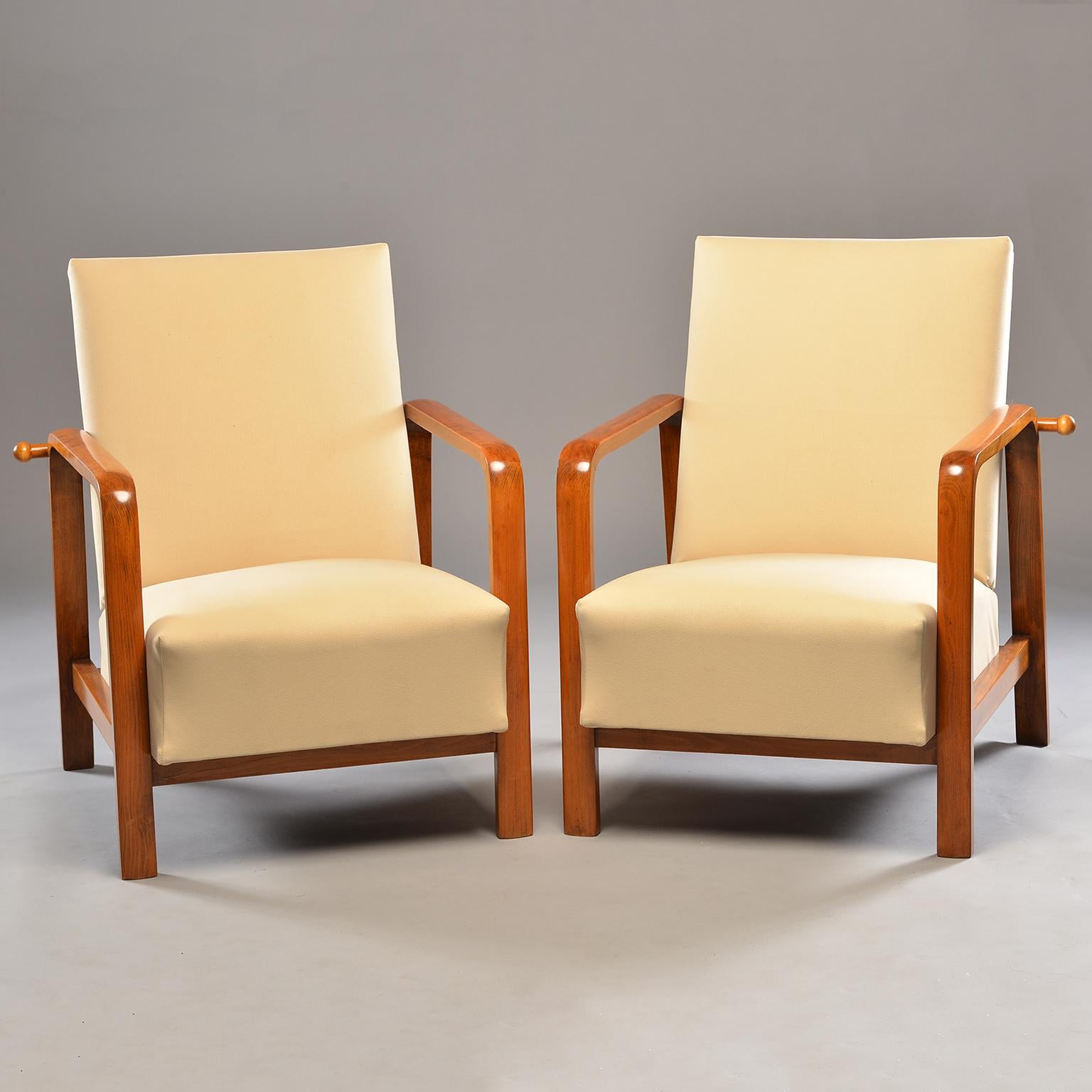 Pair of Italian reclining armchairs, circa 1930s. Chairs have polished palisander frames and updated cream colored moleskin upholstery. Adjustable wood bars in back allow chairs to recline. Arms are 24.5” high. Seats are 17.5” high. Seat depth is