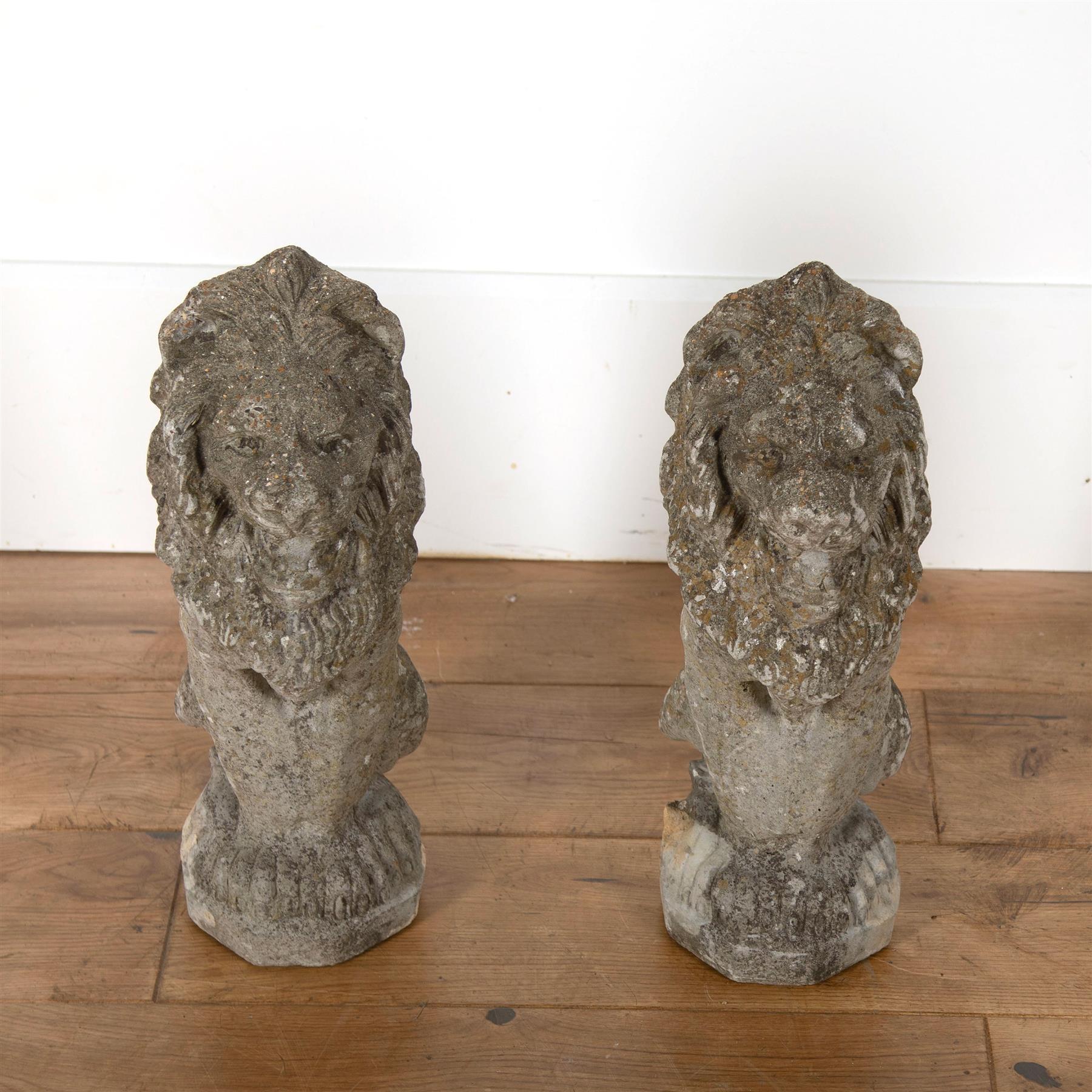 A diminutive pair of reconstituted stone lions of good worn colour and with lichen.