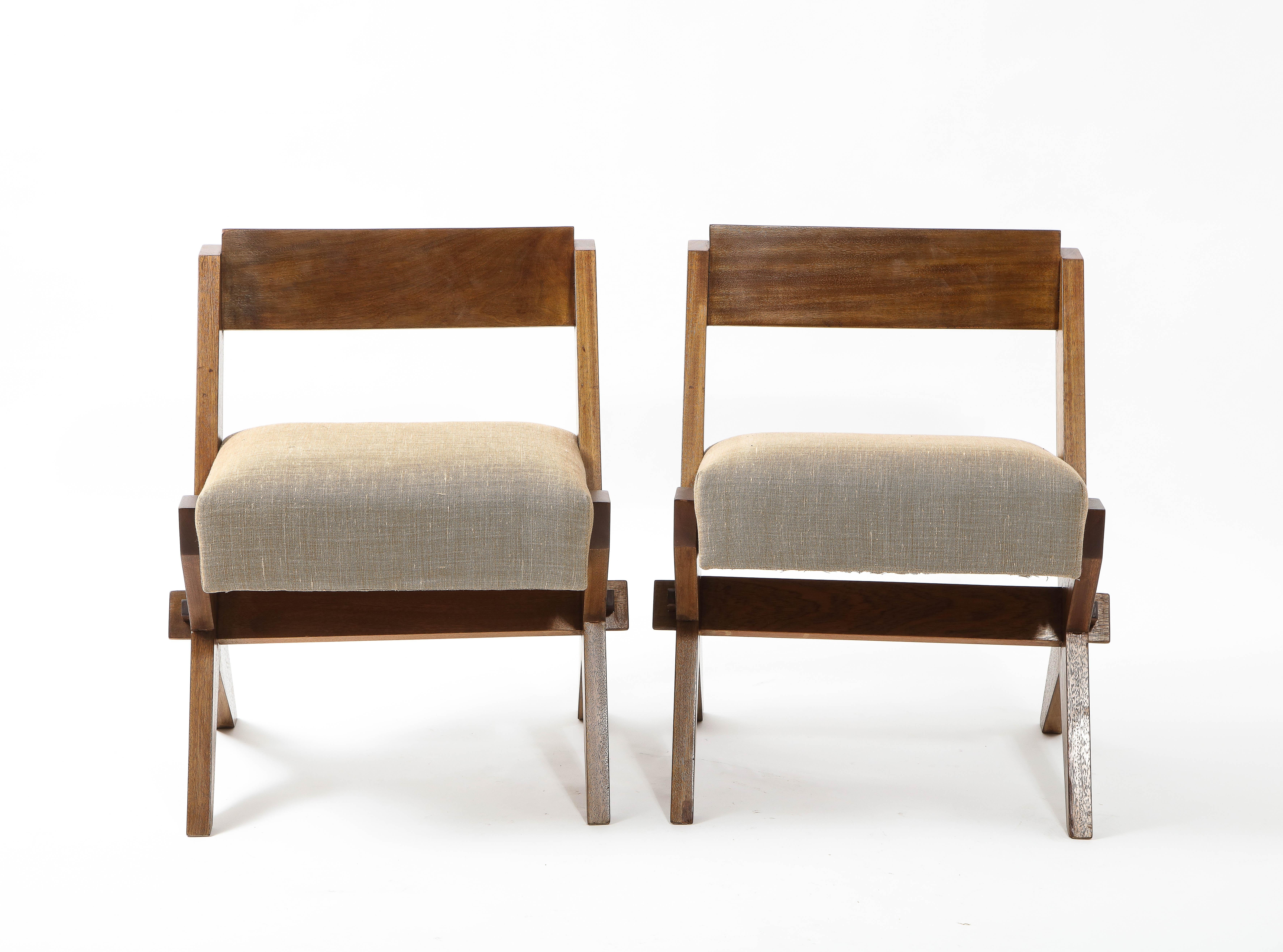 Solidly constructed walnut side chairs in the style of Jeanneret, of note, are the 