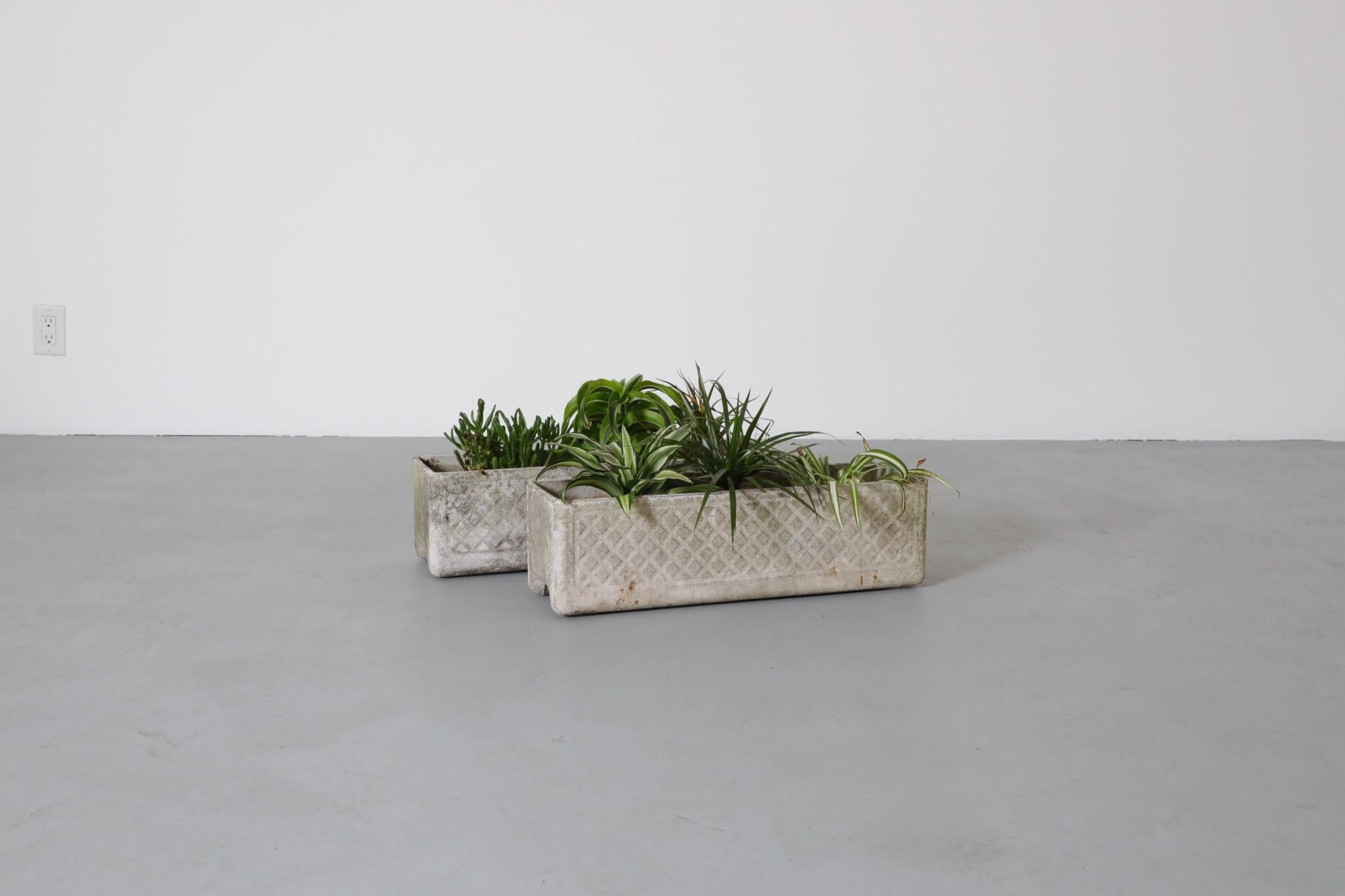 Pair of low rectangular trough planters attributed to Swiss architect Willy Guhl. Raw and minimalistic planters with a subtle imprinted carvings on the sides. For outdoor use. In very original condition with visible wear consistent with their age