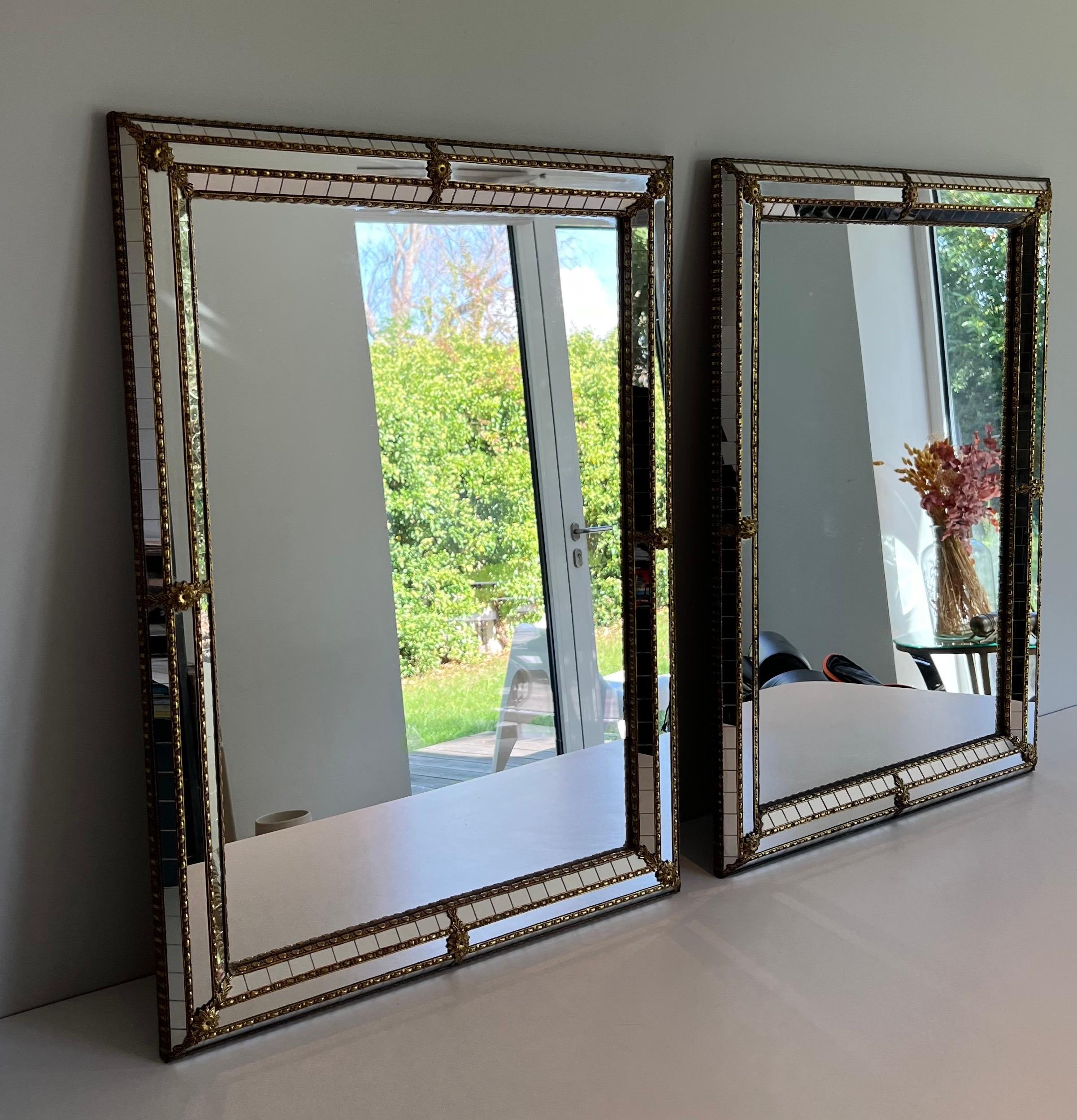 This very nice pair of rectangular is made of  multi-facets mirrors with brass garlands. This is a very fine and decorative work. This is French work. Circa 1970