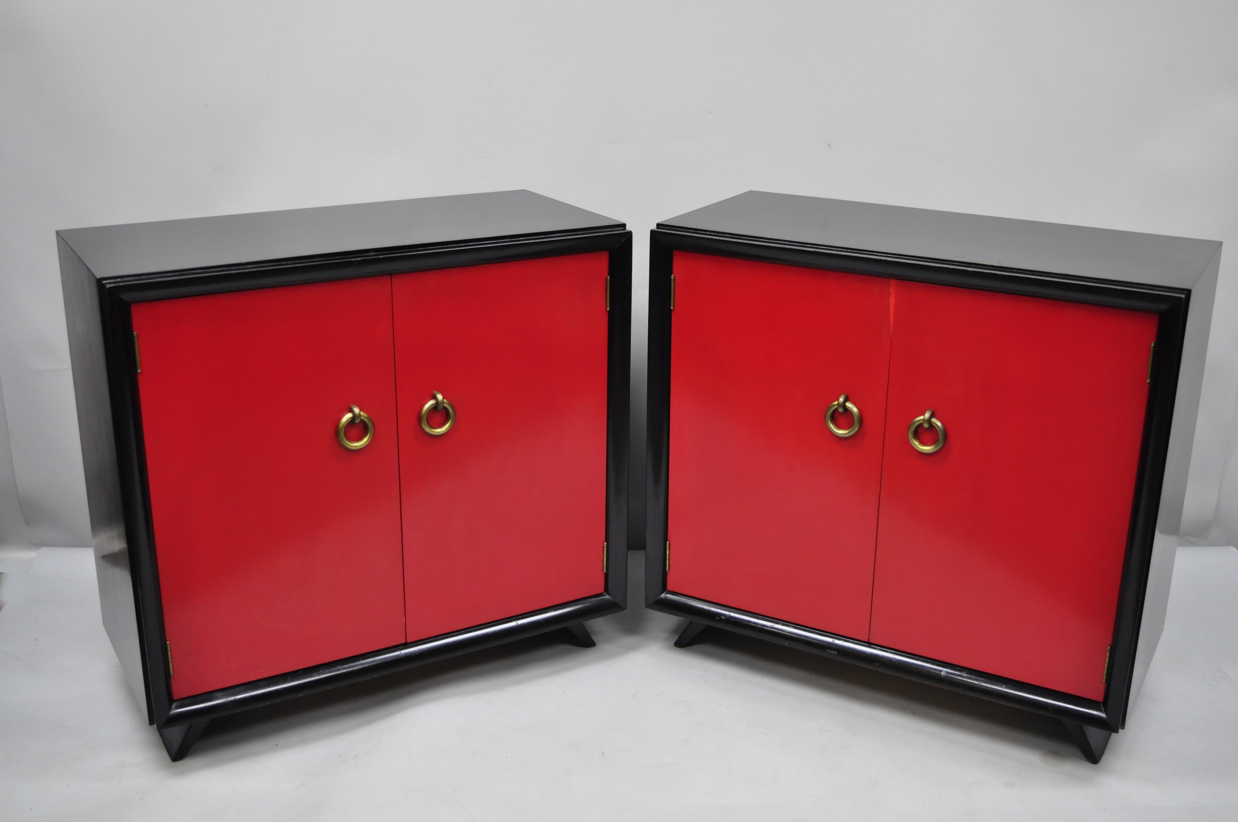 Pair of red and black Art Deco Mid-Century Modern cabinet commodes by Harjer. Item features black and red lacquer finish, 2 swing doors, 1 adjustable shelves, tapered legs, solid brass hardware, clean modernist lines, quality American craftsmanship,