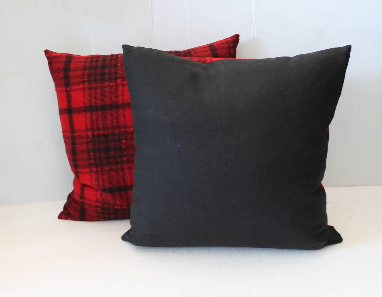 Fantastic black and red wool blanket pillows with a black cotton linen backing. The inserts are down and feather fill. Sold in pairs. Two pairs in stock.