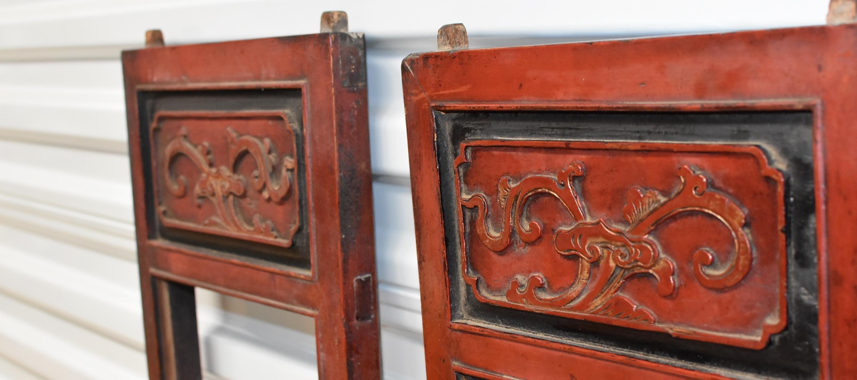 A pair of beautiful Chinese Antique screens in black, red and gold. The carvings depict opera scenes. On one screen, a Goddess standing in the pavilion handing over a sword to 2 travelers, a symbol of removing obstacle and evil spirits. On the