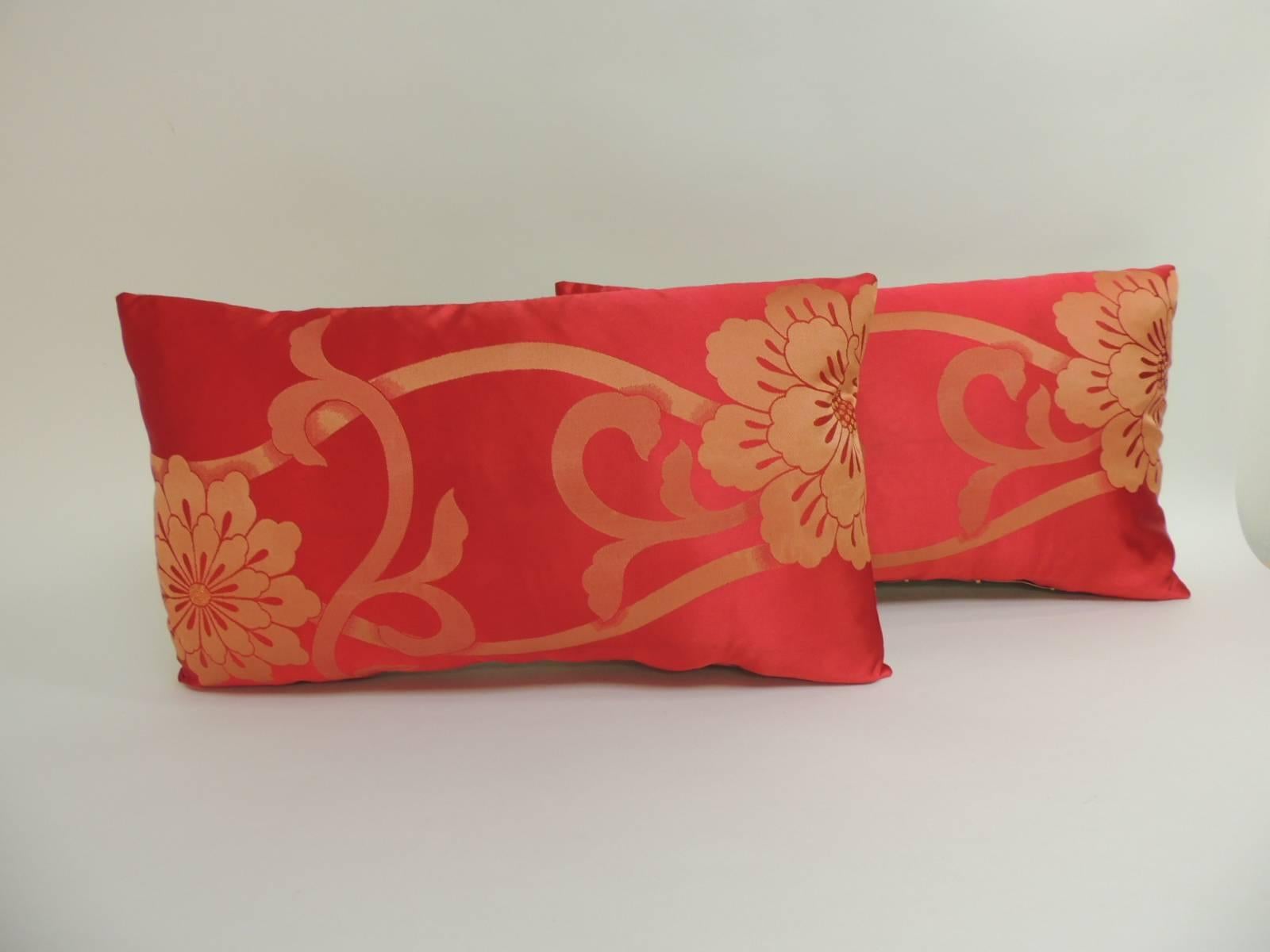Gold and red floral woven silk floral Obi lumbar pillows. Decorative pillows motif depicting flowers in bloom with large flowers with vines and leaves. The front panel flowers are embroidered with gold metallic threads. Decorative lumbar pillows