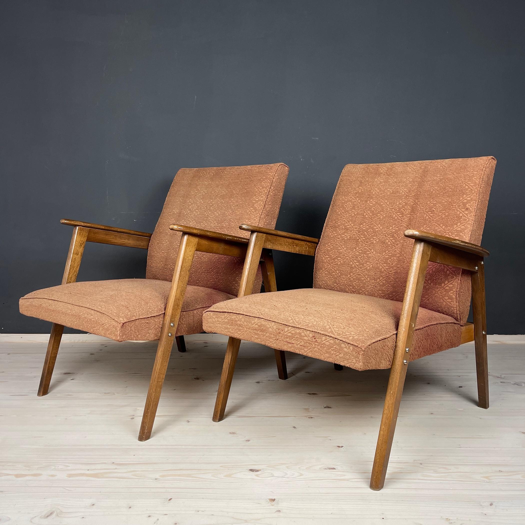 Introducing a stunning pair of red-brown mid-century armchairs, exquisitely crafted in Yugoslavia during the 1960s. These rare gems, in good condition, boast their original fabric, the quality of which is clearly depicted in the accompanying
