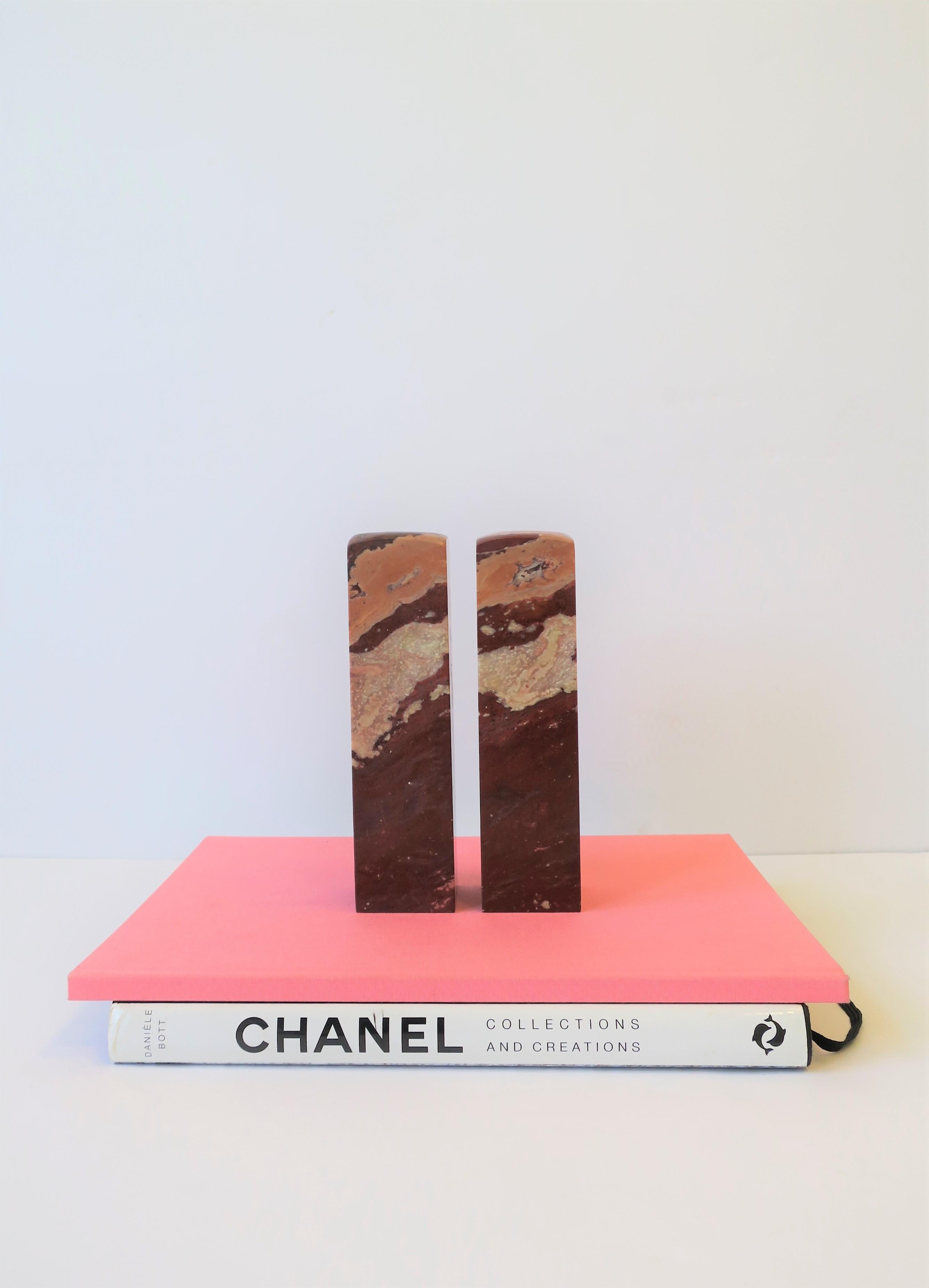 A very beautiful pair of Obelisk style, relatively tall, red burgundy/ox blood marble sculptures or bookends, circa early 20th century, China. This pair was originally designed to be Chinese decorative stamps, however, stamp area on bottom was not