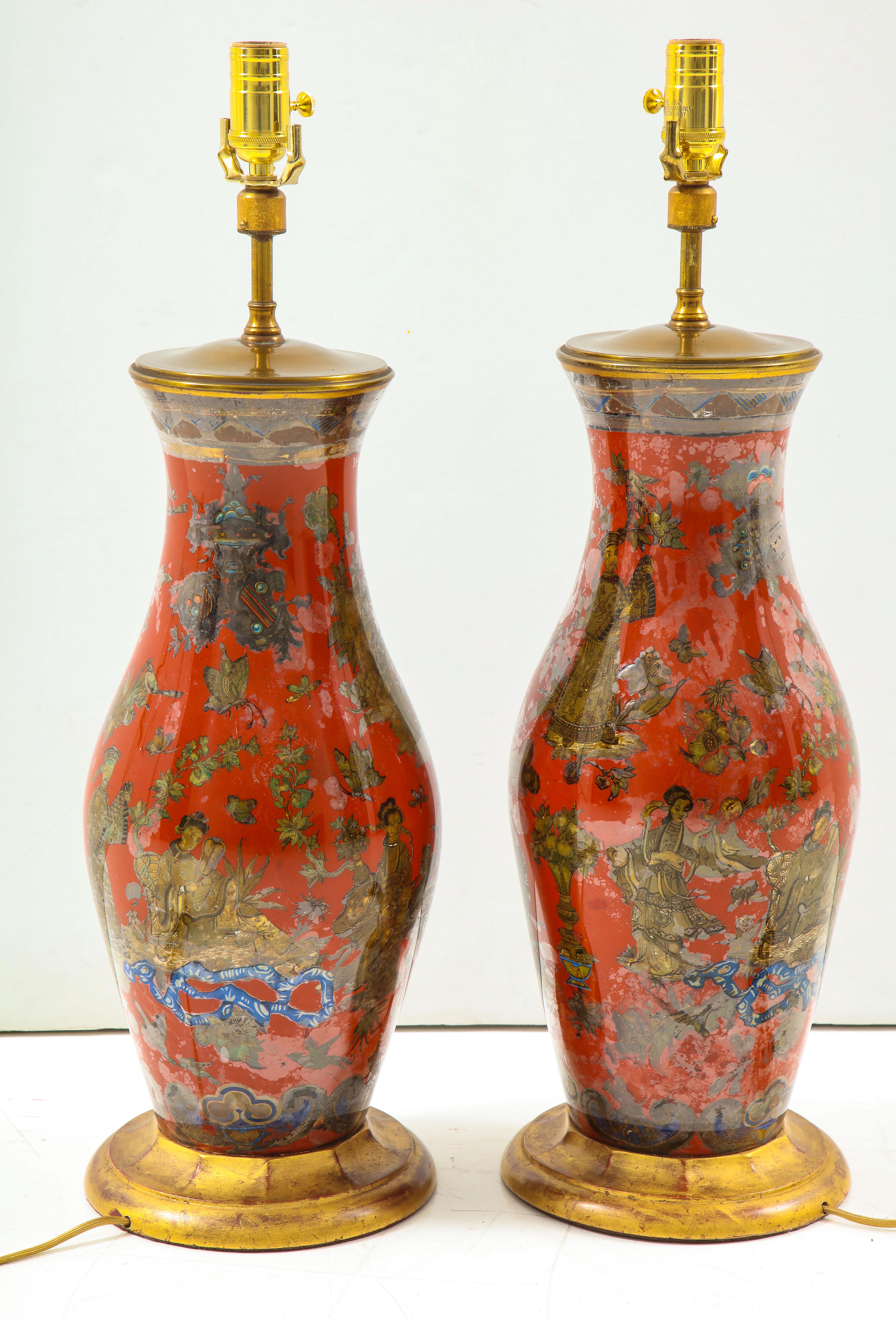 A pair of vintage chinoiserie table lamps, painted in a tomato red with giltwood base, circa 1970s.