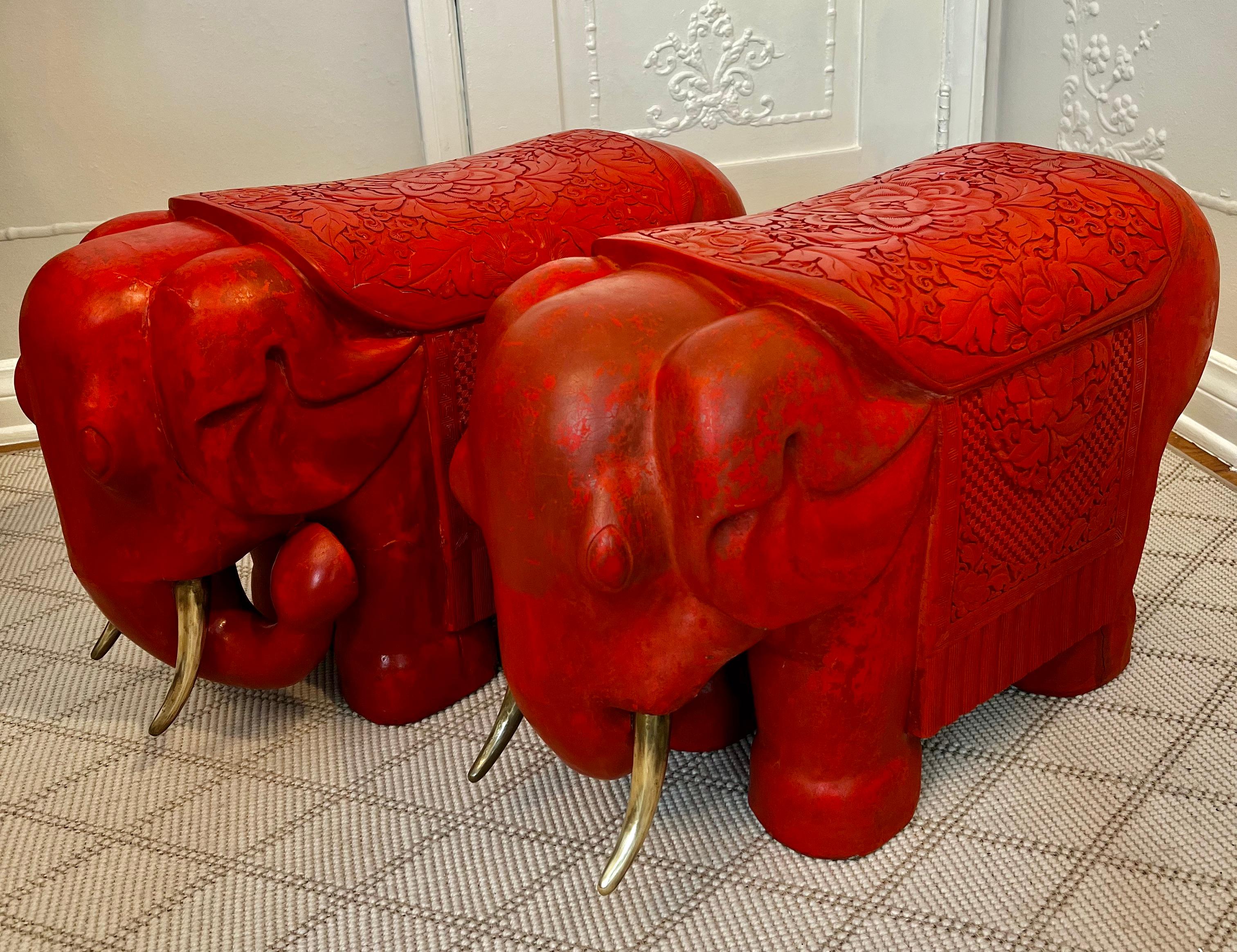 A pair of Cinnabar red hand carved elephants with solid brass tusks. the trunks are up, allowing the good energy to flow wherever you place them.

A Wonderfull statement flanking a doorway or can be used as a stool, or pull up from under a console