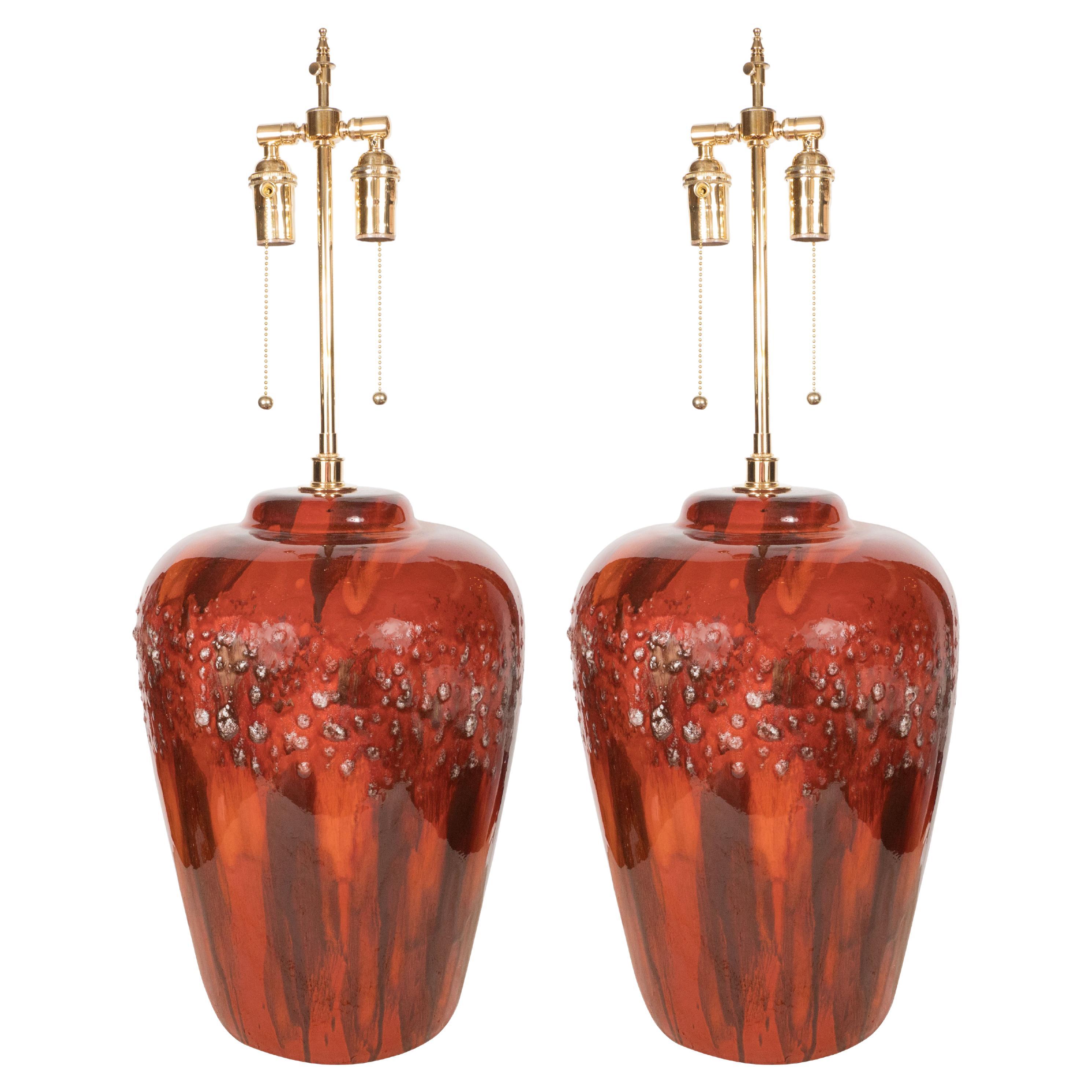 Pair of Red Glazed Pottery Lamps with Brass Details For Sale