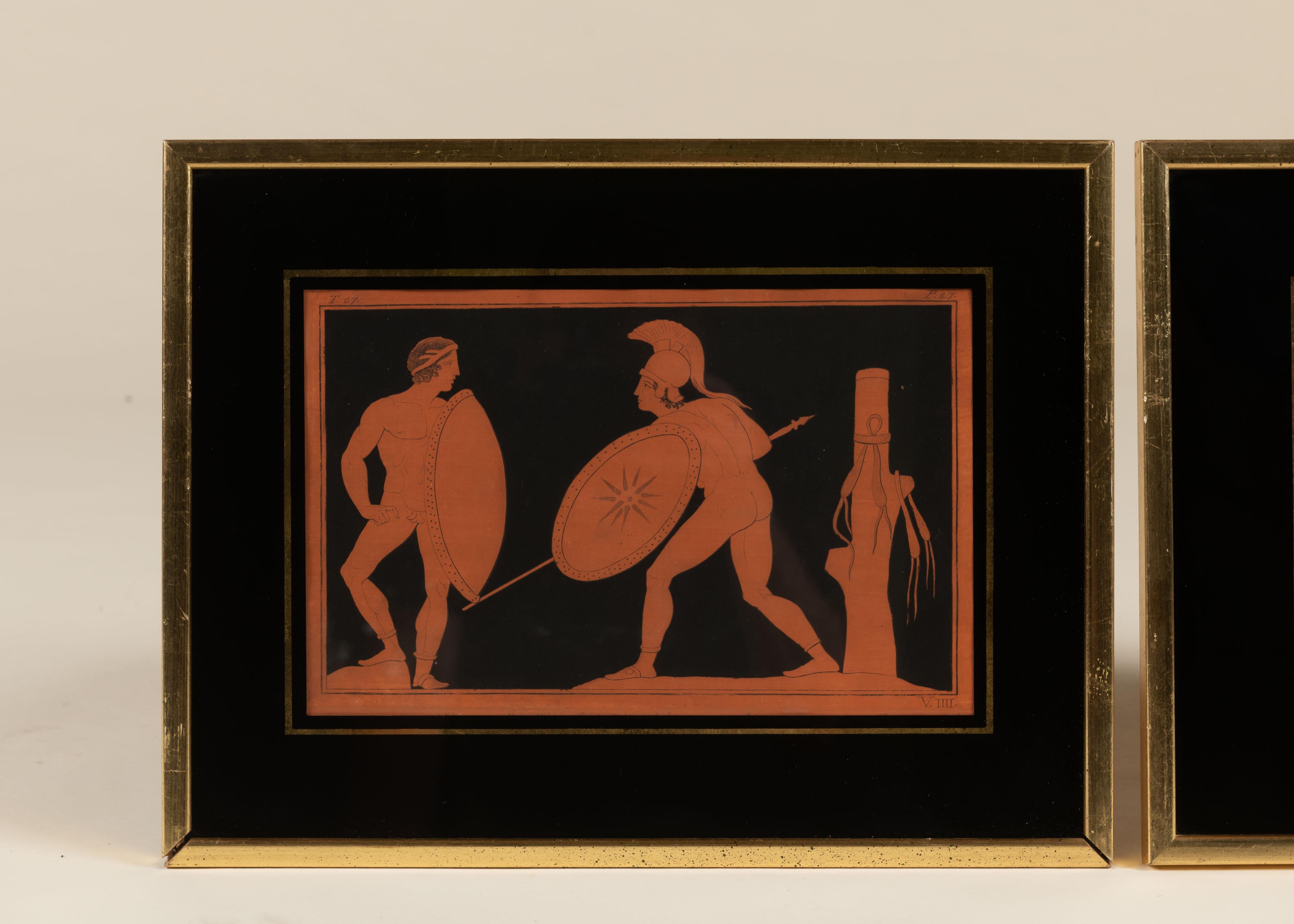 A vintage pair of framed prints inspired by the red-figure pottery of ancient Greece, dating to the mid-20th century. One depicts two armed warriors in profile, the other shows three robed figures in a ceremonial scene. Printed in terracotta tones