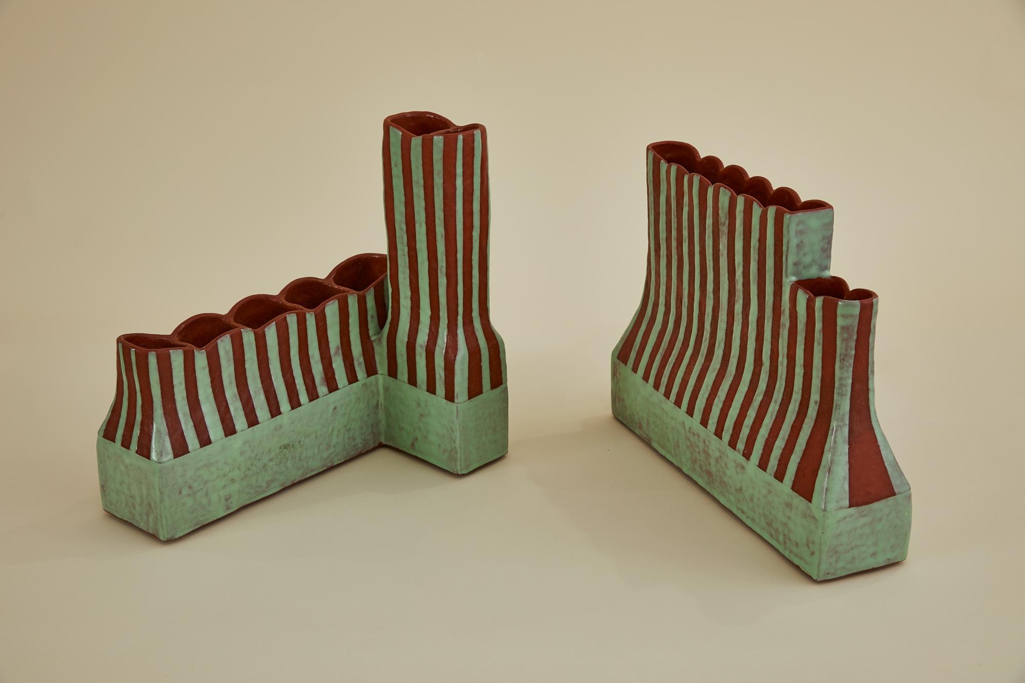 A striking pair of handmade ceramic vases by contemporary artist Rebecca Chapell, first exhibited as part of a solo gallery exhibition. These asymmetrical sculptural vessels feature separated chambers, allowing for the arrangement of individual
