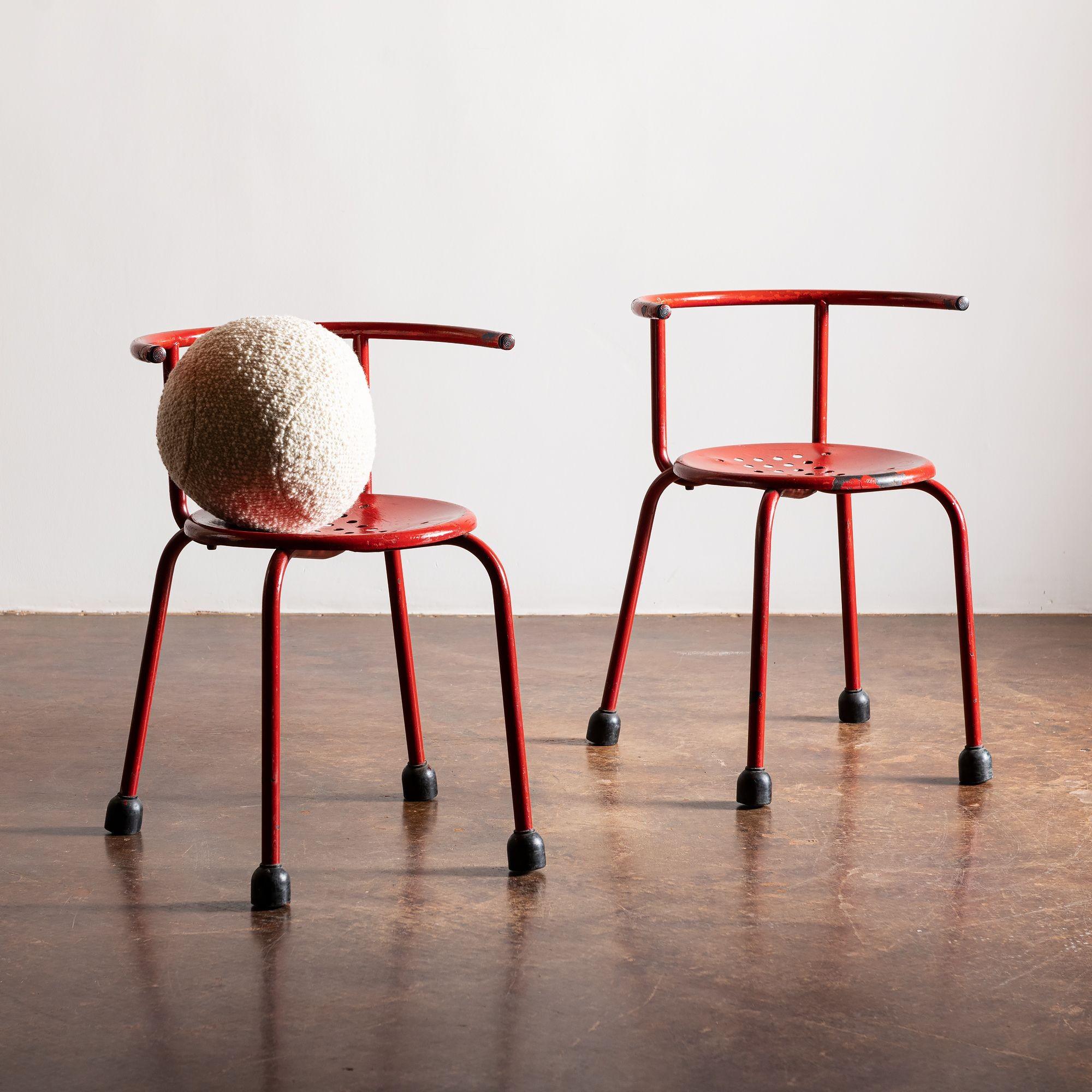 A vintage pair of red iron chairs by Sottsass with lovely patina. Italy, 1960s.