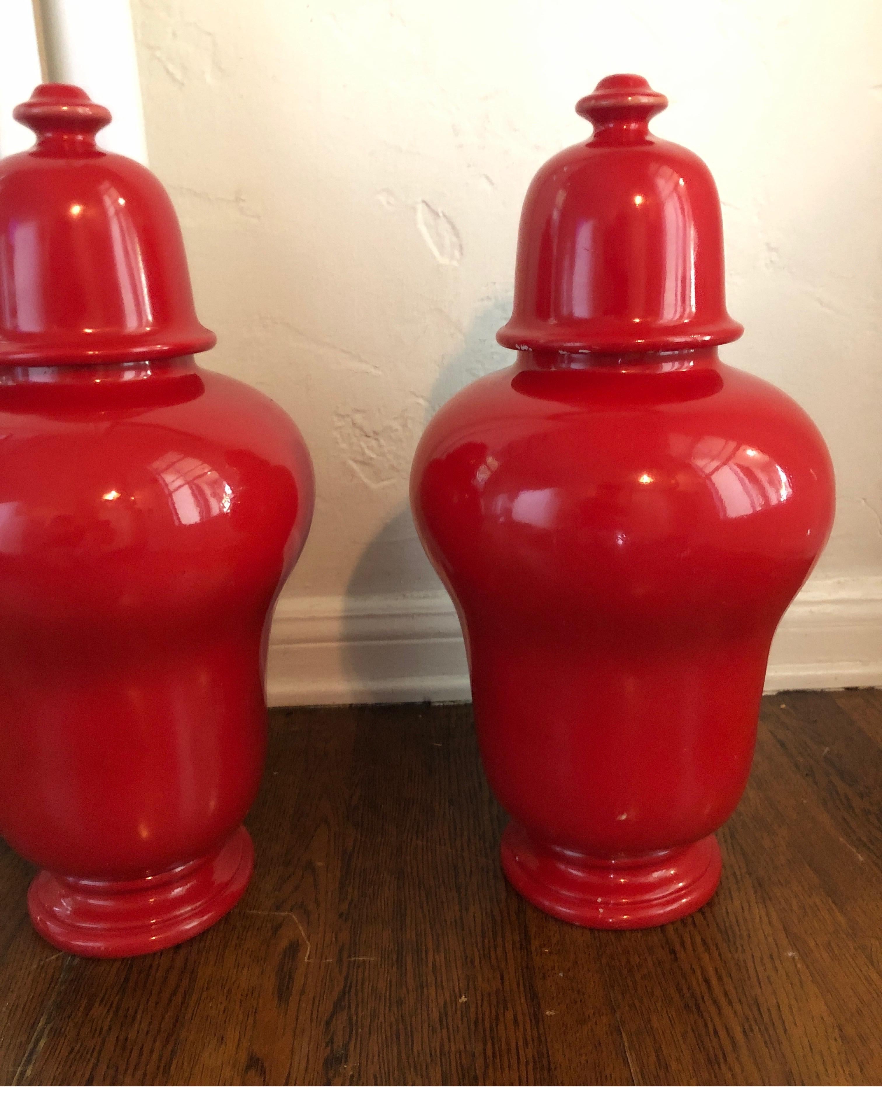 Pair of vintage red Jars with removable lids.
Measures: 20” tall x 10” wide 

Defined by their round body, high shoulders and dome lid. Timeless Chinese Baluster jars.
Traditionally decorated with a red lacquered finish. 
Please note, one urn