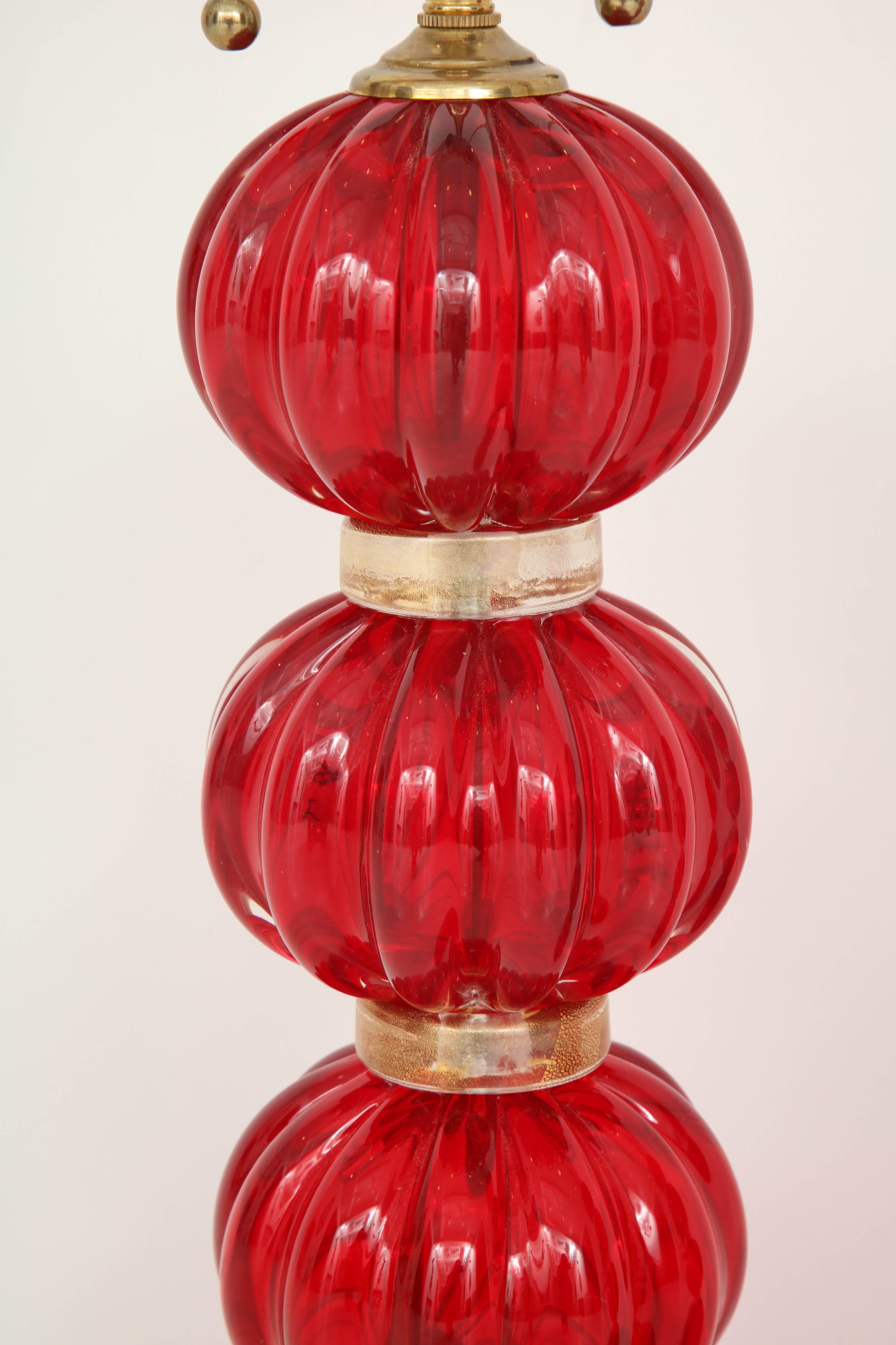Add some color and personality to a room with these gorgeous red Murano glass lamps. Composed of three fluted 