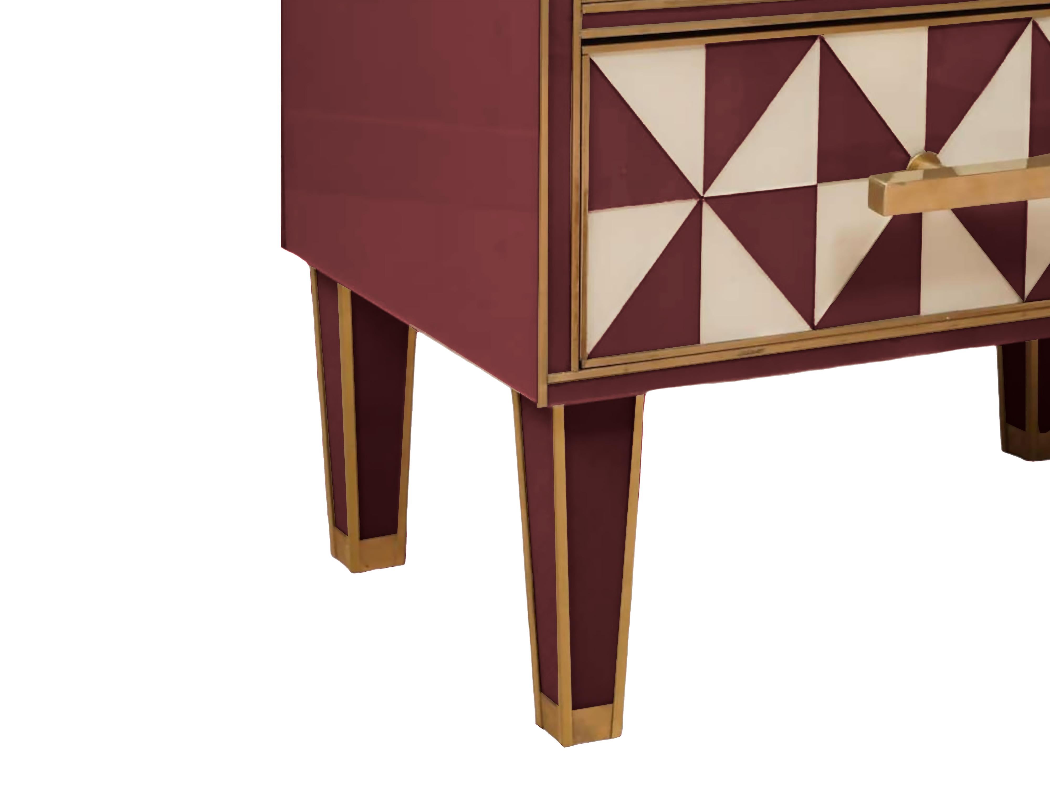 This pair of red and white Murano glass “optical” nightstands with brass trim is a stunning representation of mid-century modern design inspired by the elegance of the 1950s. 

Each side table features a solid wood frame adorned with vibrant red and