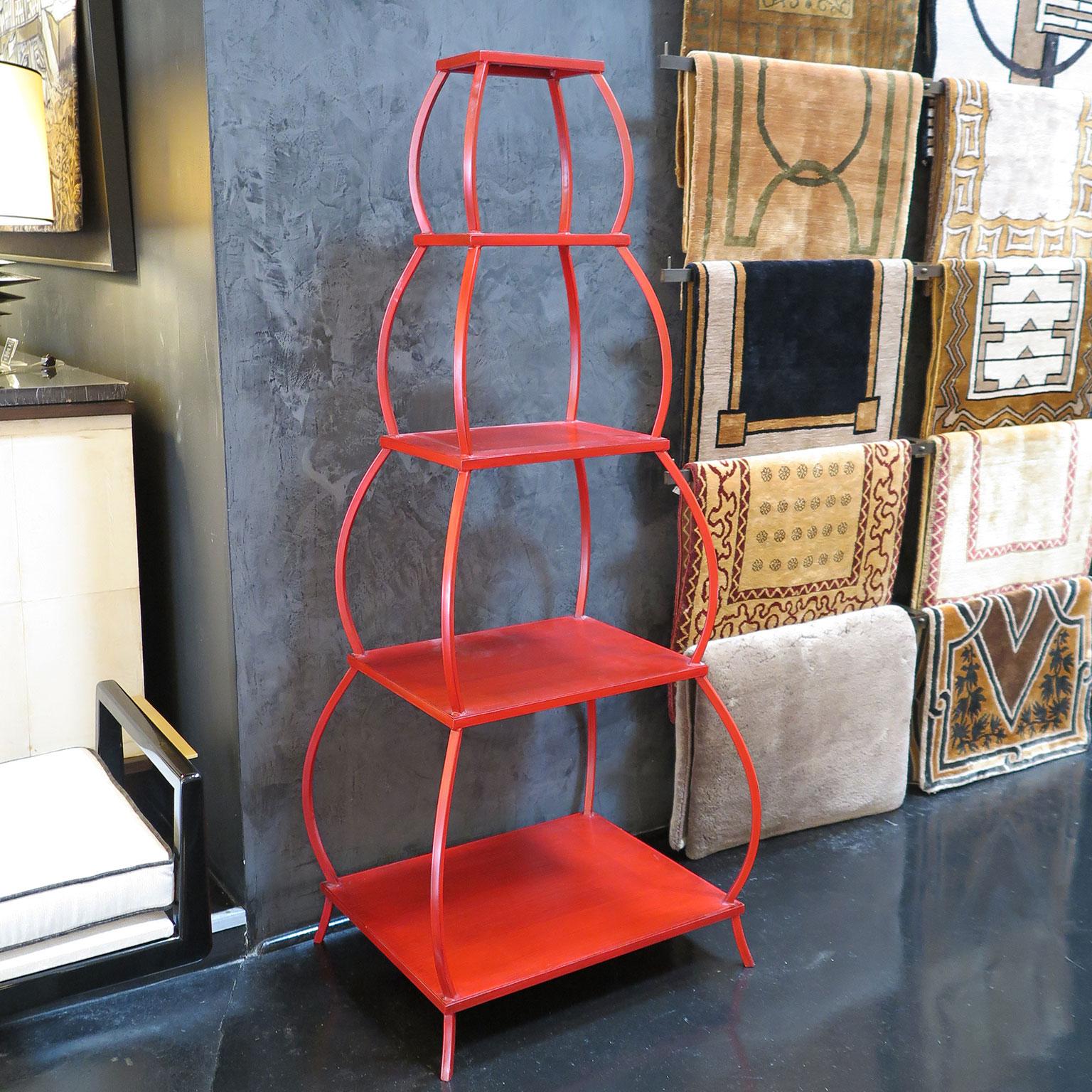 Vintage metal étagères in aged Chinese red lacquer in the style of a pagoda. Five tapered tiers with scalloped outer frame.