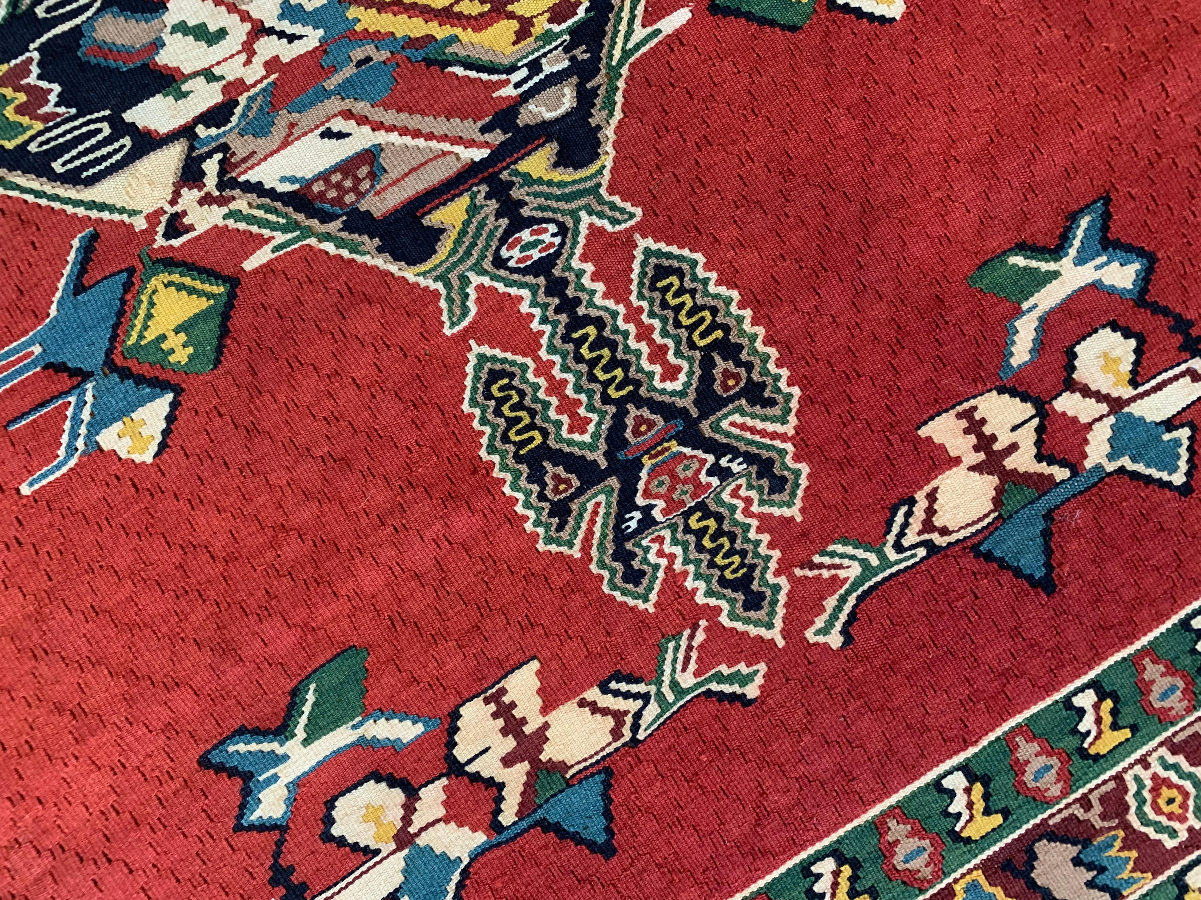 These beautiful Rugs are handmade, flatwoven kilims woven in the early 21st century, circa 2010. It is unused and so is in excellent condition. The design features a bold red background that has been decorated with an intricate decorative geometric