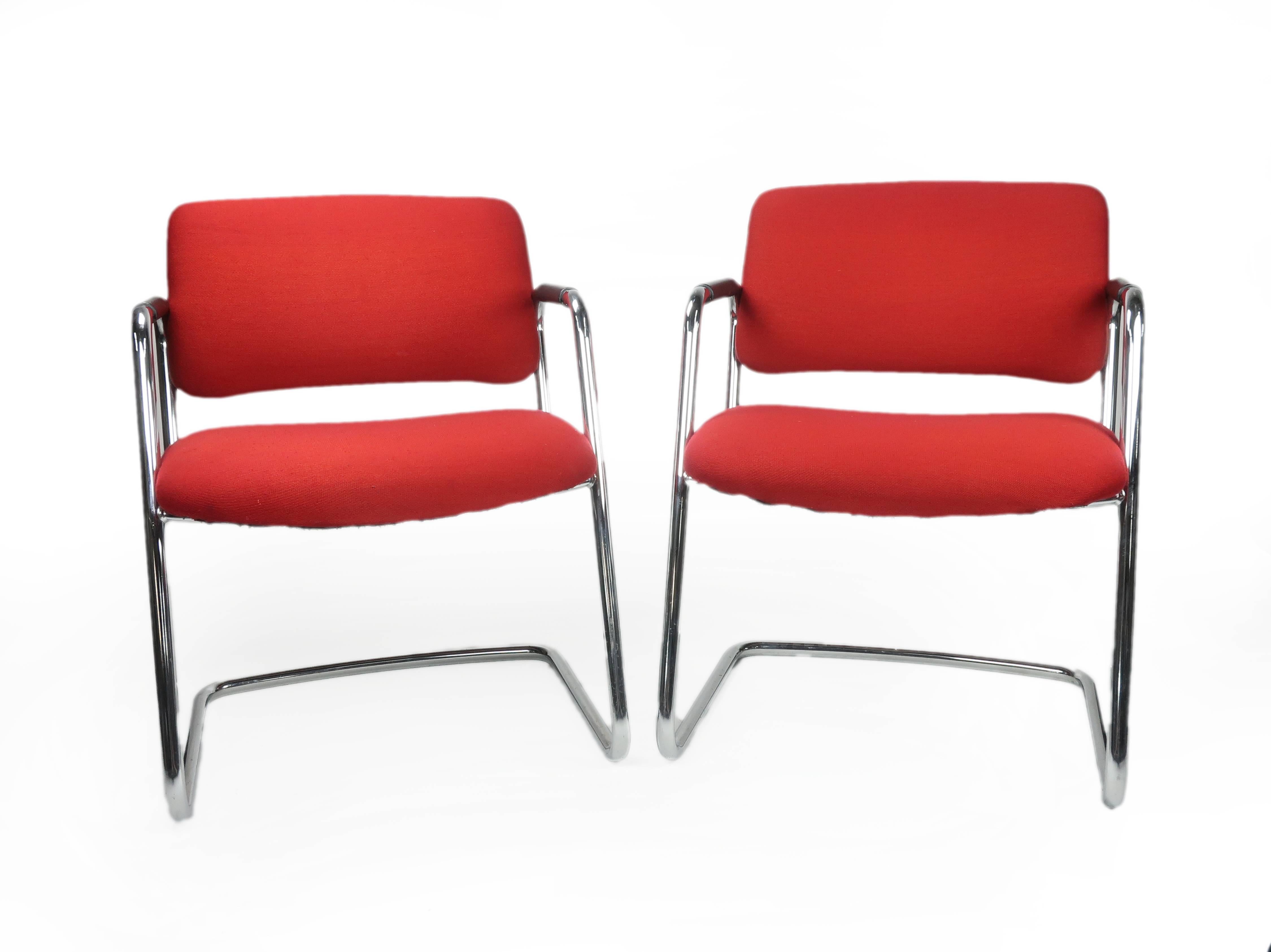 A pair of wonderful cantilevered vintage Steelcase chairs in chrome and red from the 1970s. They have their original midcentury fabric showing only light age-appropriate wear. Each has a Steelcase label and a lovely shape and heft - perfect for an