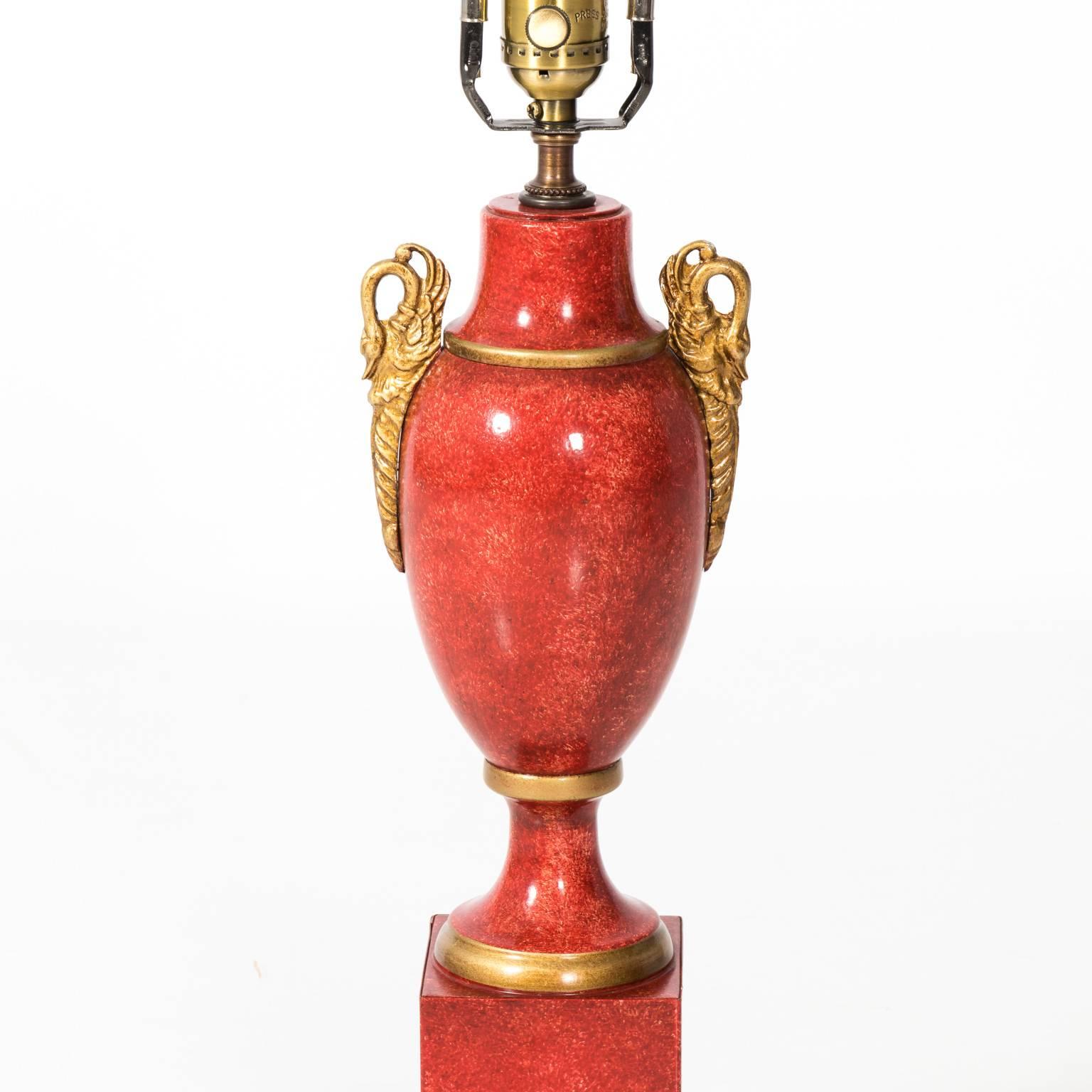 Pair of red tole French Empire style lamps with swan details. Please note that this piece does not have matching finials.
 