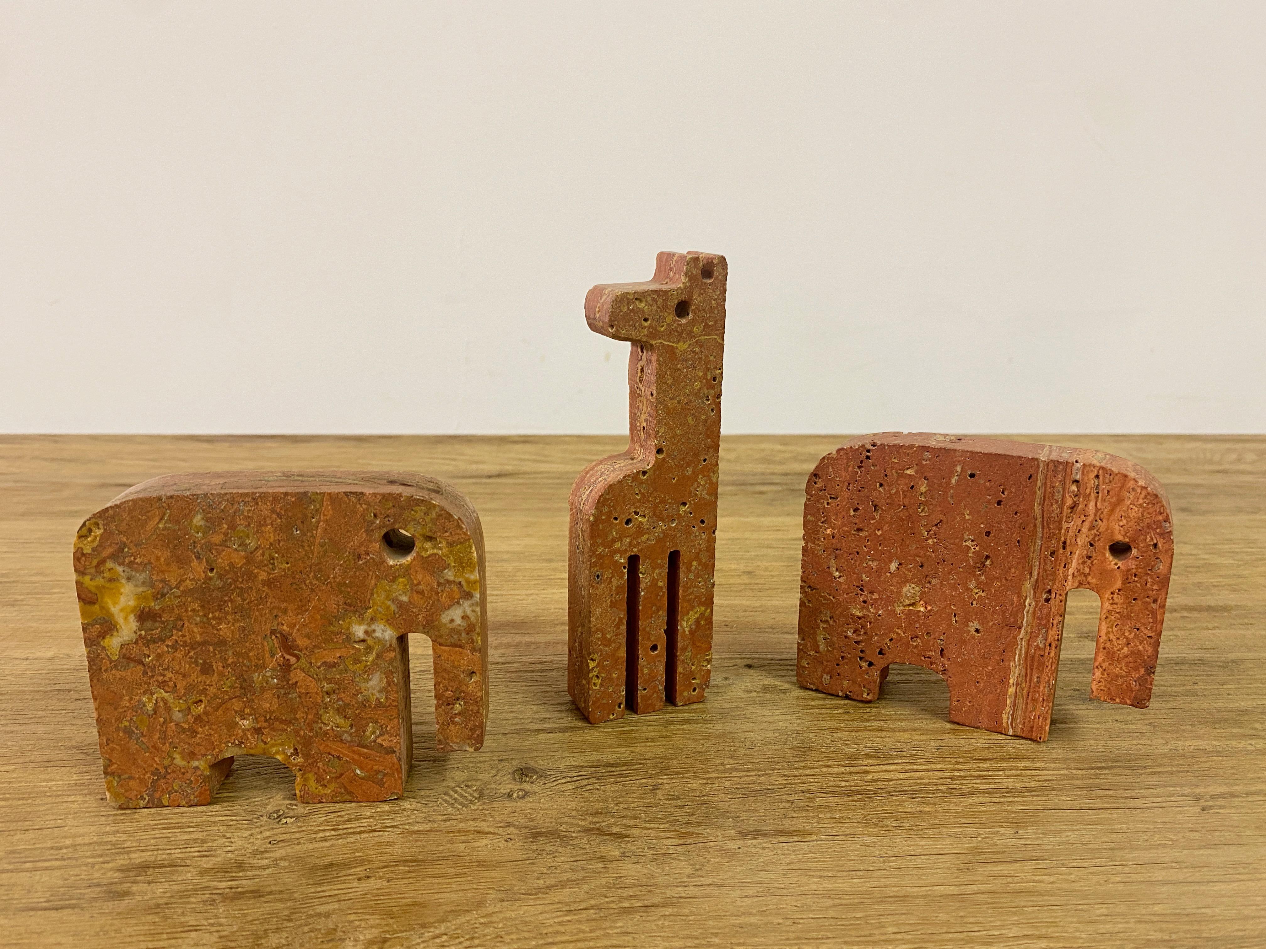 Mid-Century Modern Pair Of Red Travertine Elephant Bookends And A Giraffe For Sale
